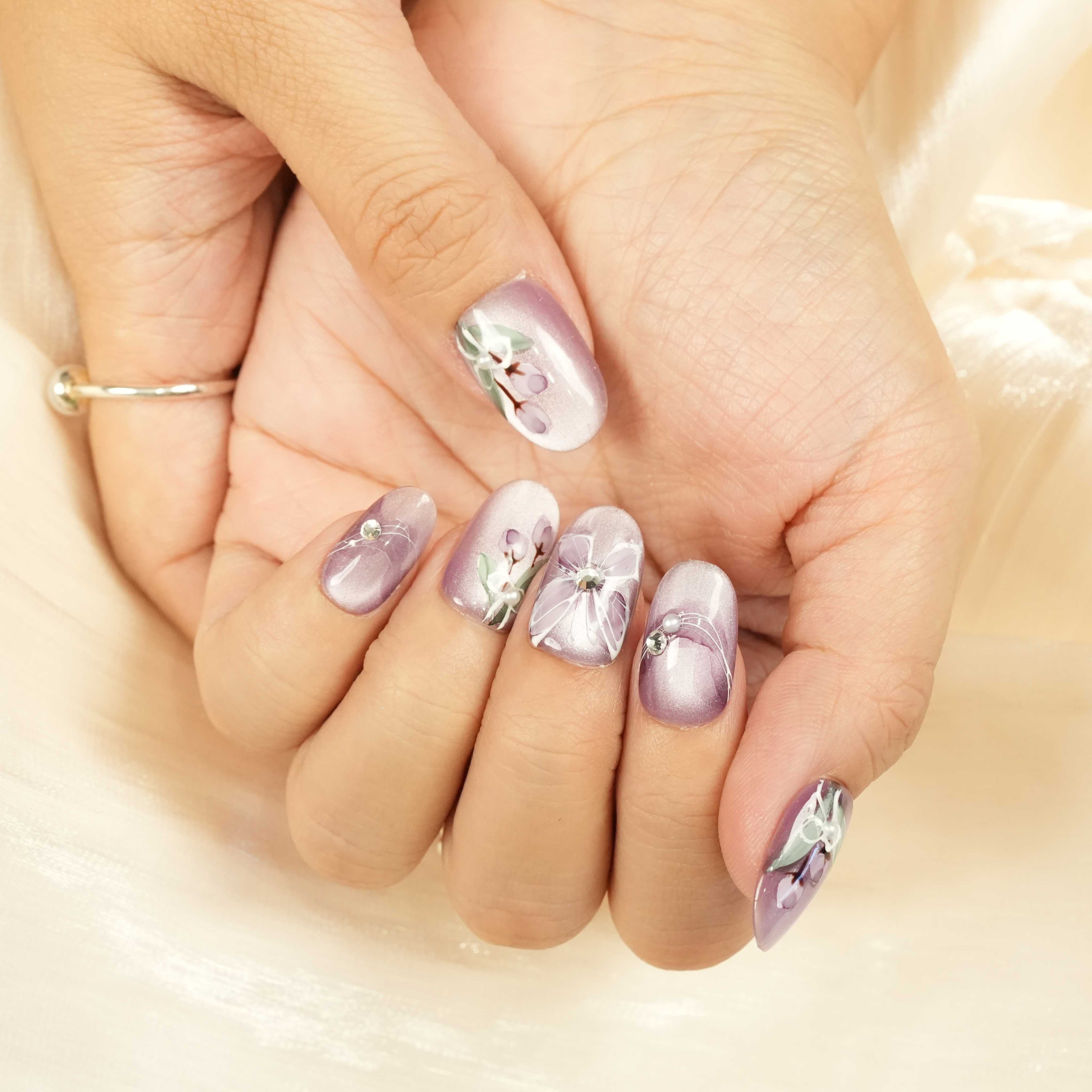 Elegant purple stick on nails with white flower designs, crystal embellishments, and shimmer ombré finish. Reusable false nails Adelaide