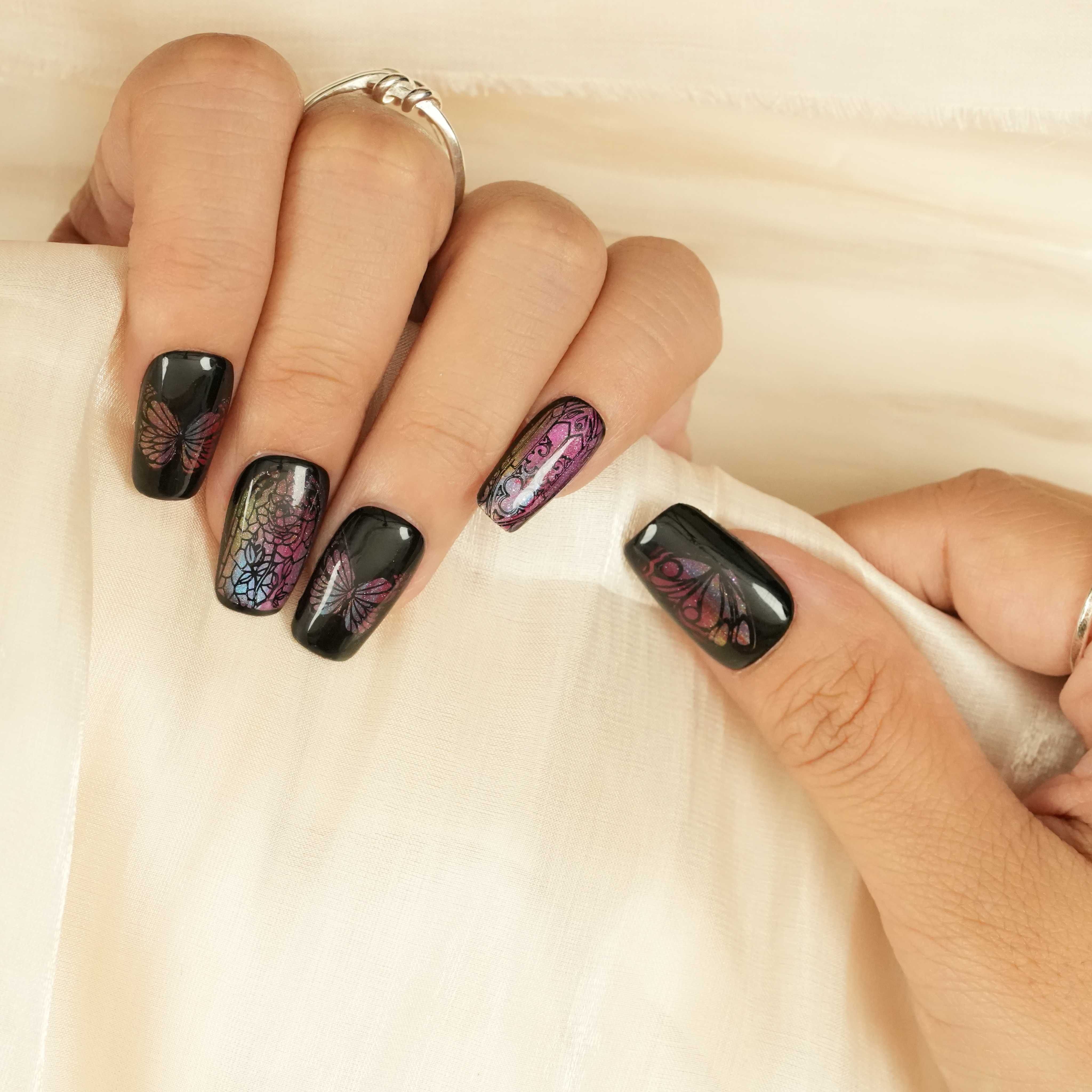 Short coffin stick on nails with black base, stained glass butterfly patterns, and subtle iridescent shimmer. Australian press on nails