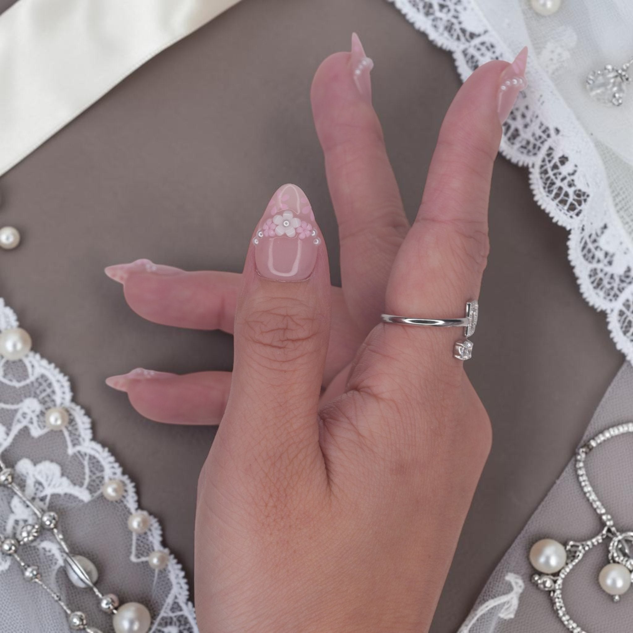DSC00041 hand wearing coquette press on nails with a 3D flower and silver caviar beads