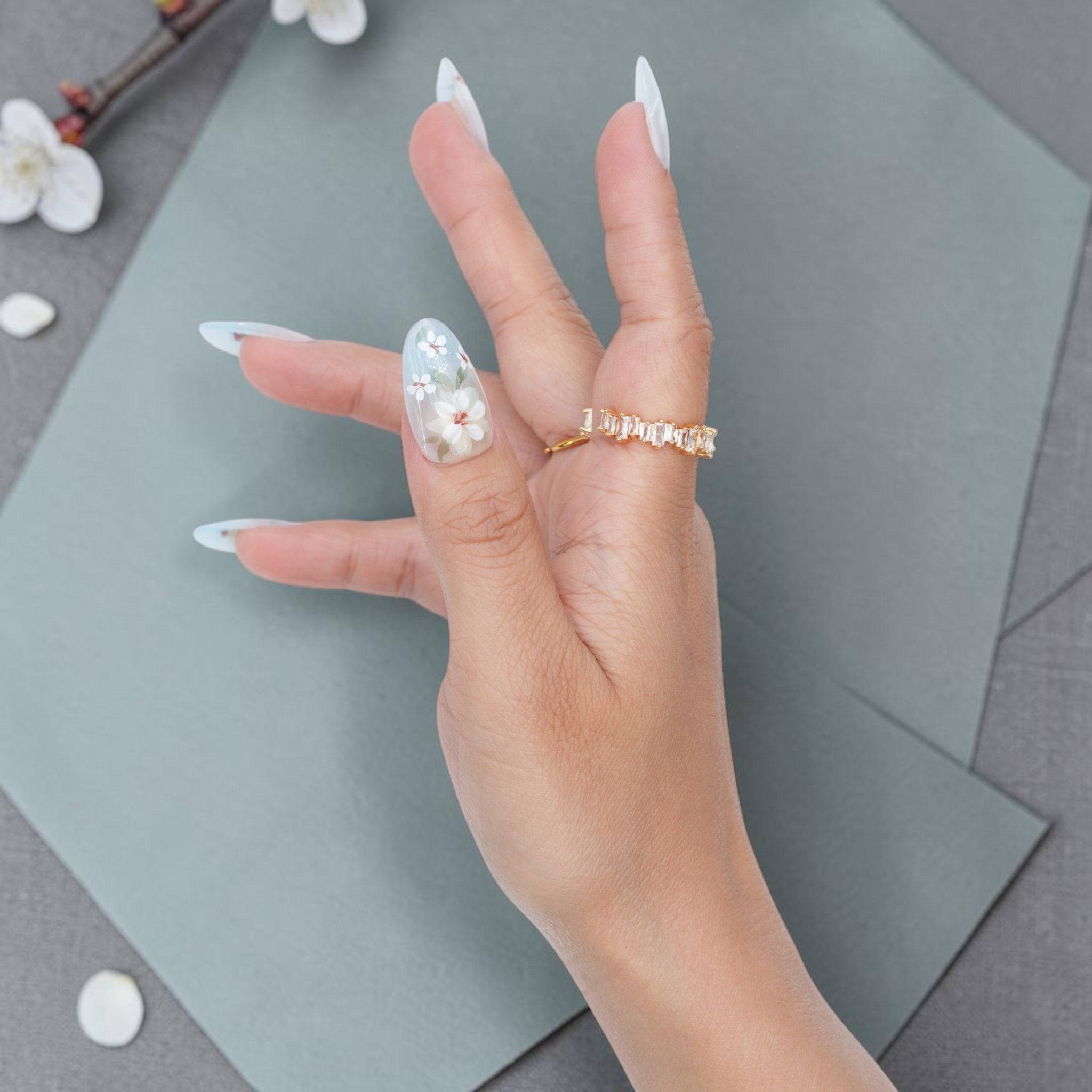 DSC00055 close up of hand painted white blossoms on a milky press on nail