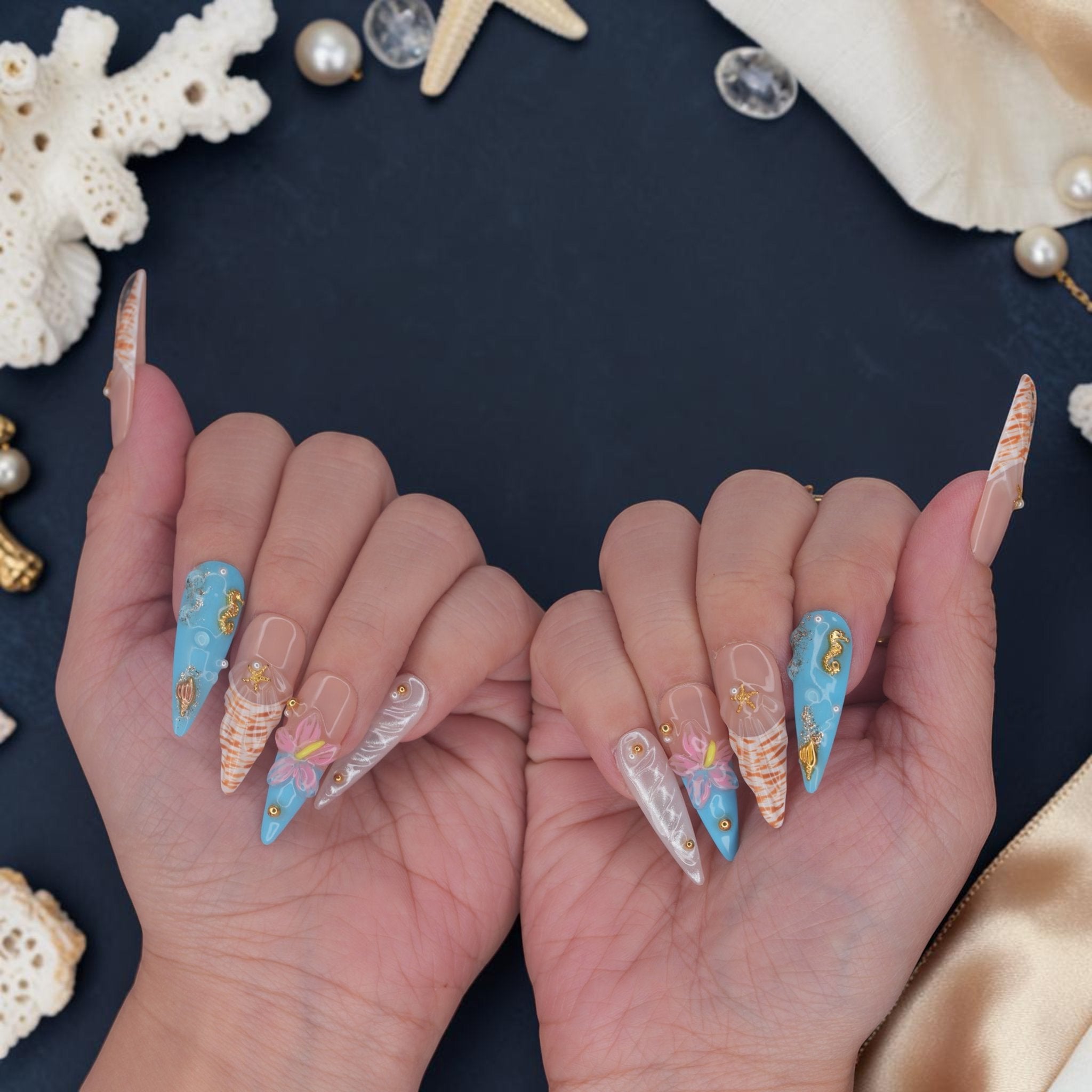 DSC00070 hands wearing mermaid press on nails with ocean blue, gold seahorses and starfish