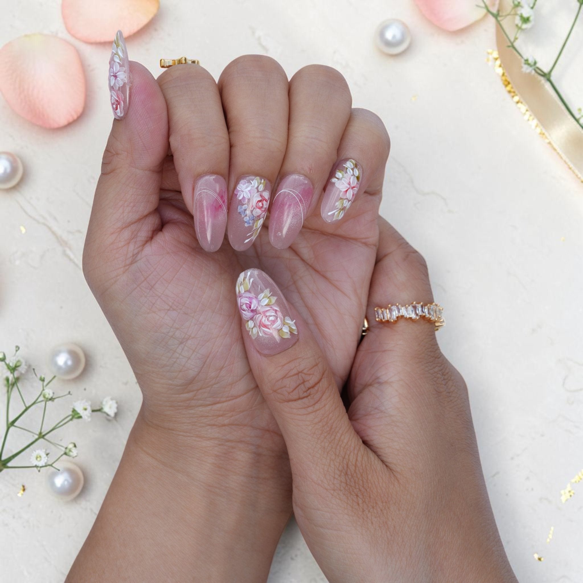 Oval watercolour press on nails with pink roses and white flowers on a pearly base