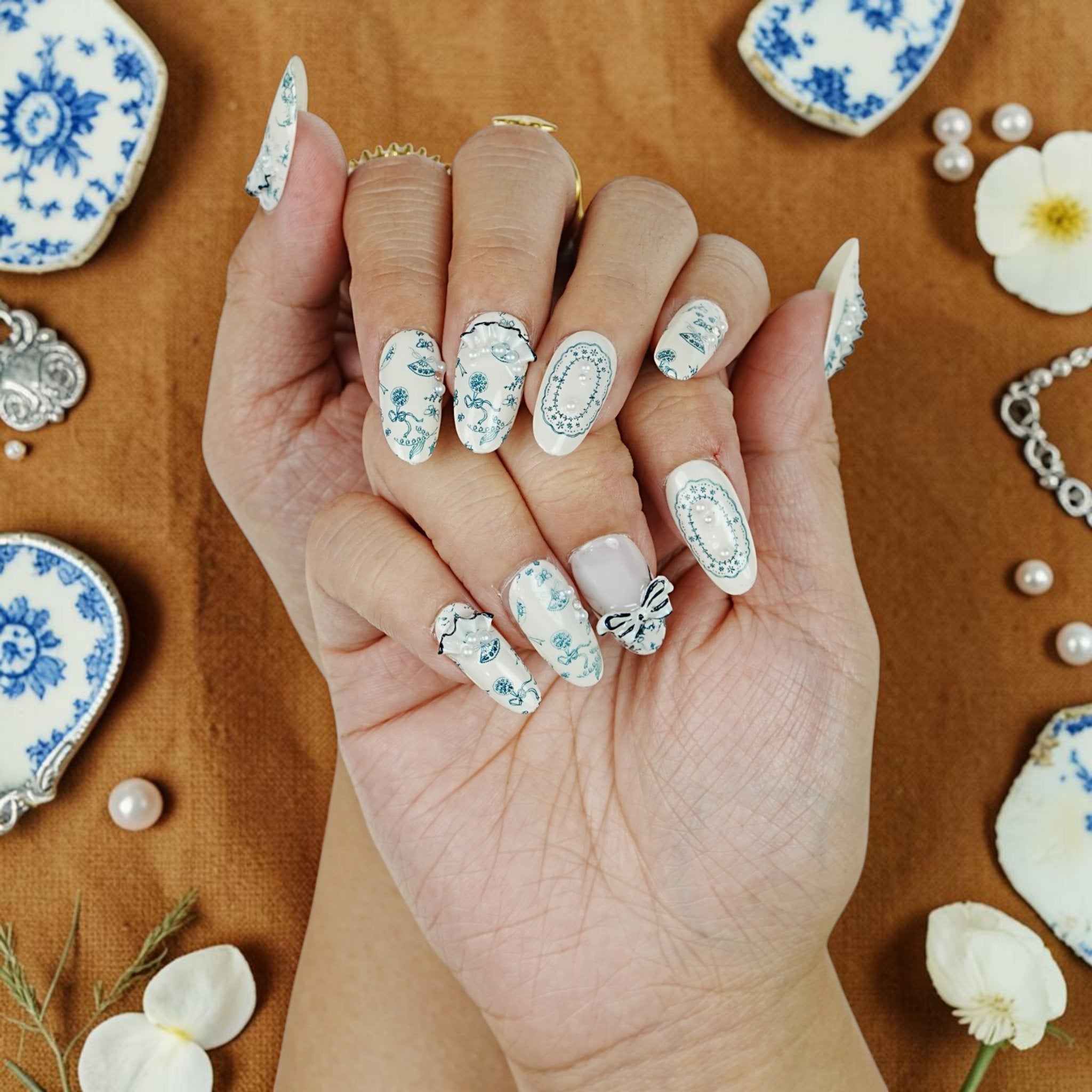 DSC00094 handmade porcelain press on nails in blue and white on a vintage china flat lay