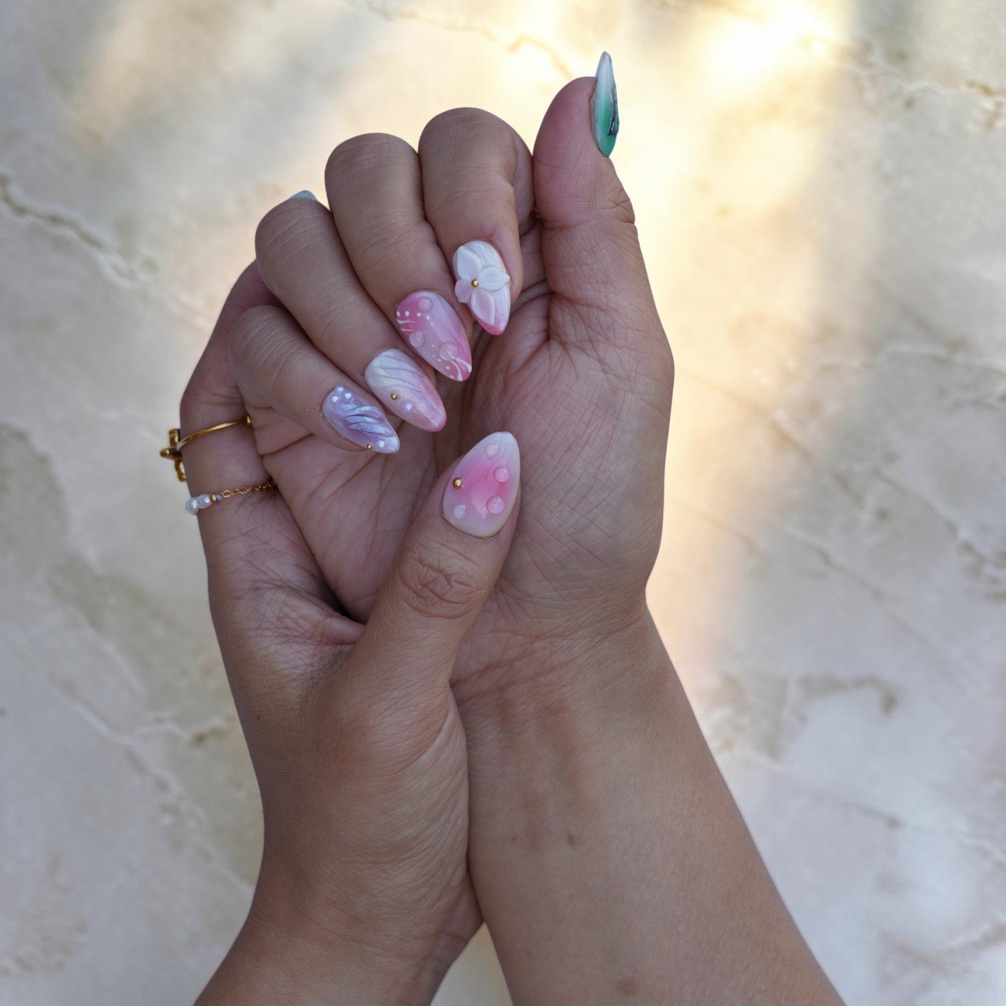 Pastel iridescent press on nails on both hands with dewdrops and silver swirls