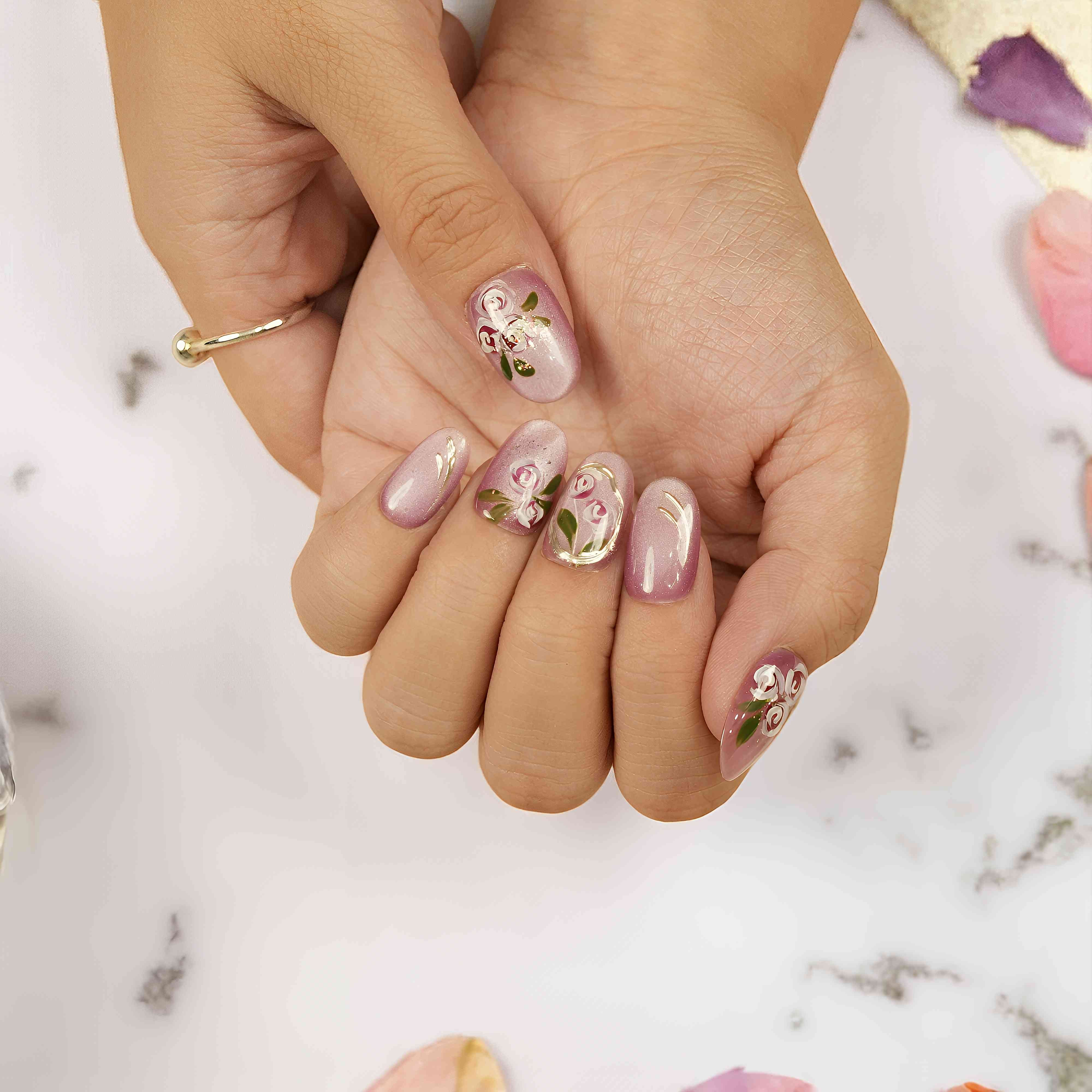 Close-up of hand-painted floral nails with cat’s eye shimmer – reusable press on nails for women