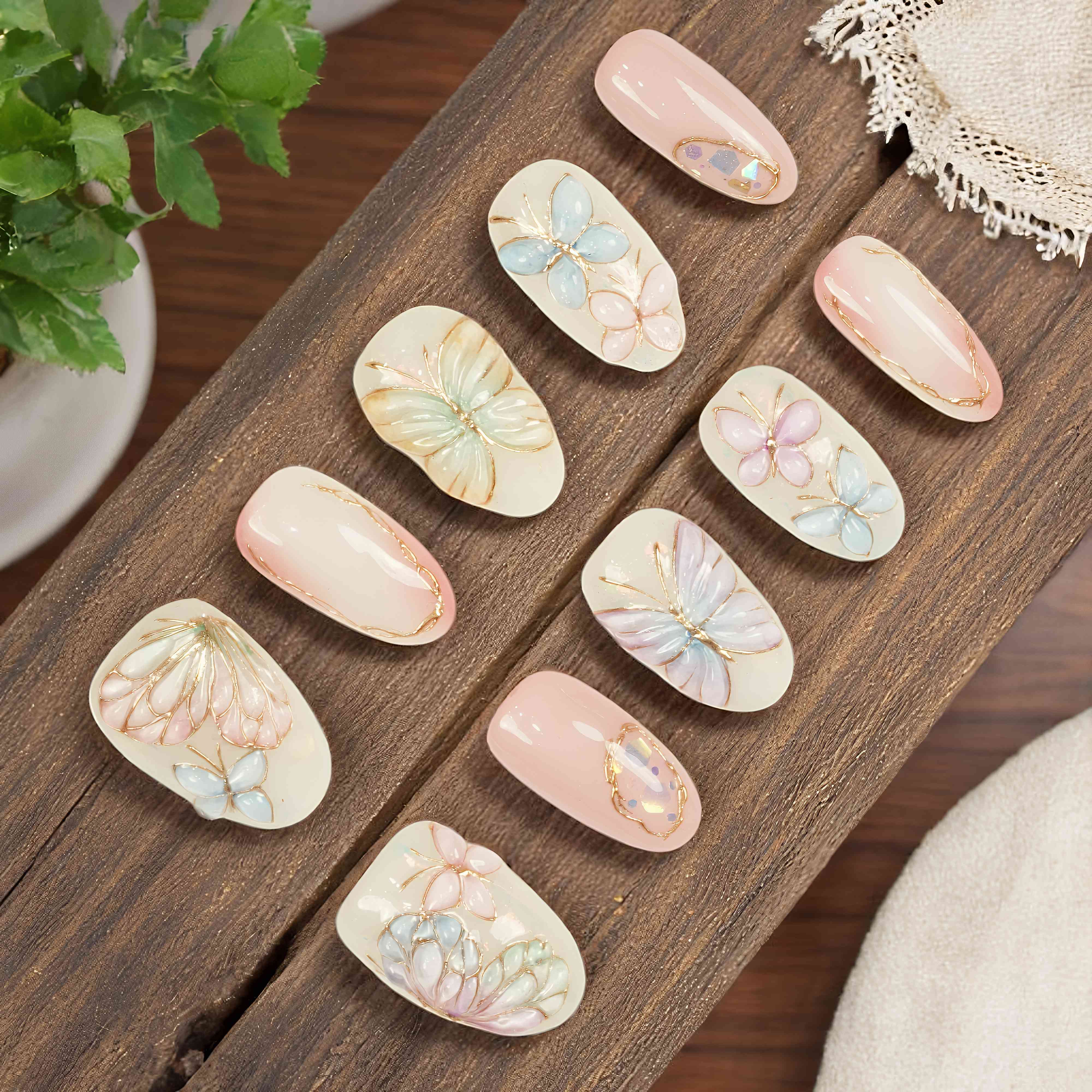 Pastel butterfly press on nails flat lay – handmade floral design with 3D wings