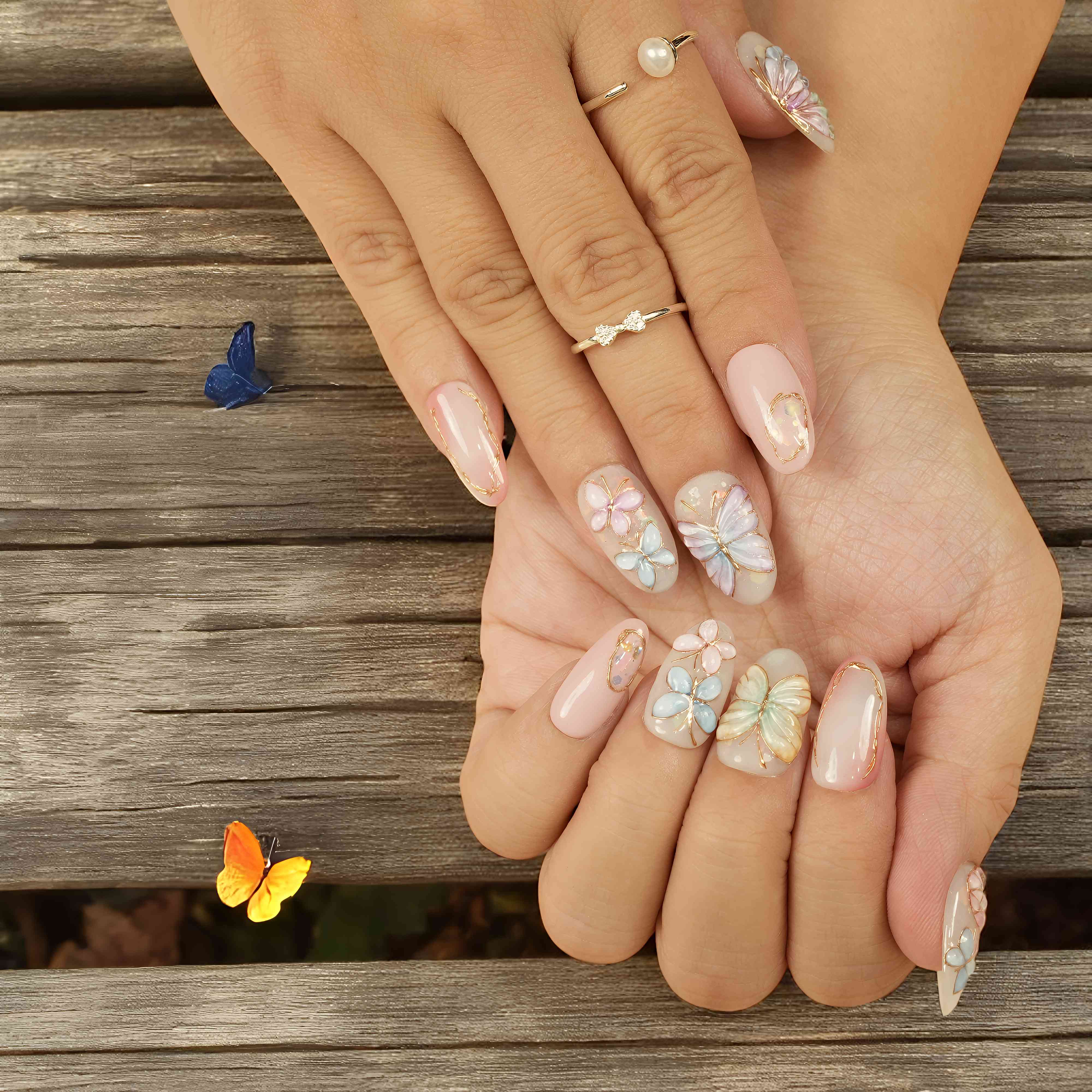 Elegant butterfly nails worn in sunlight – almond shape pastel nails Australia