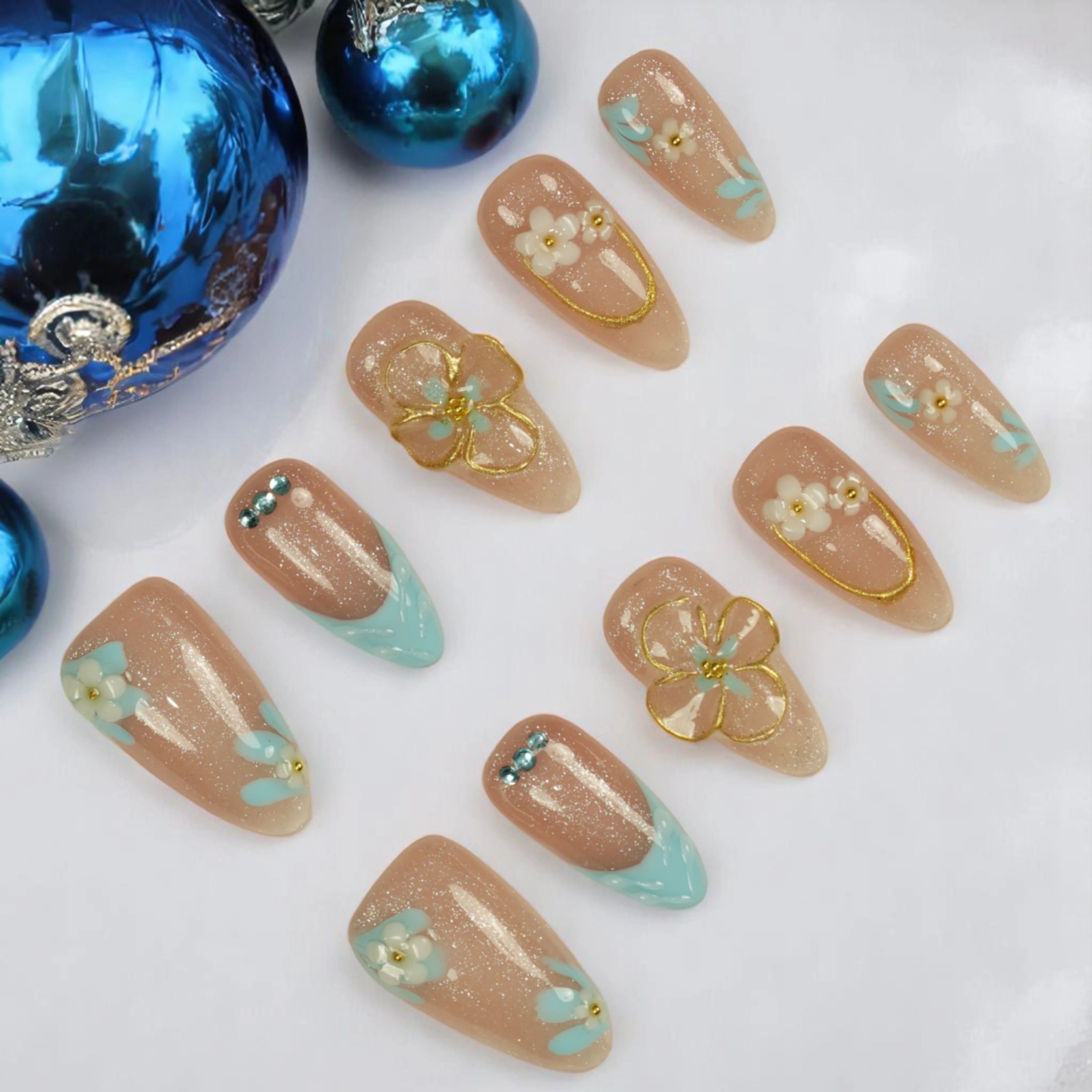 Pastel floral press on nails with nude shimmer base and blue French tips – Bluebell Bloom set