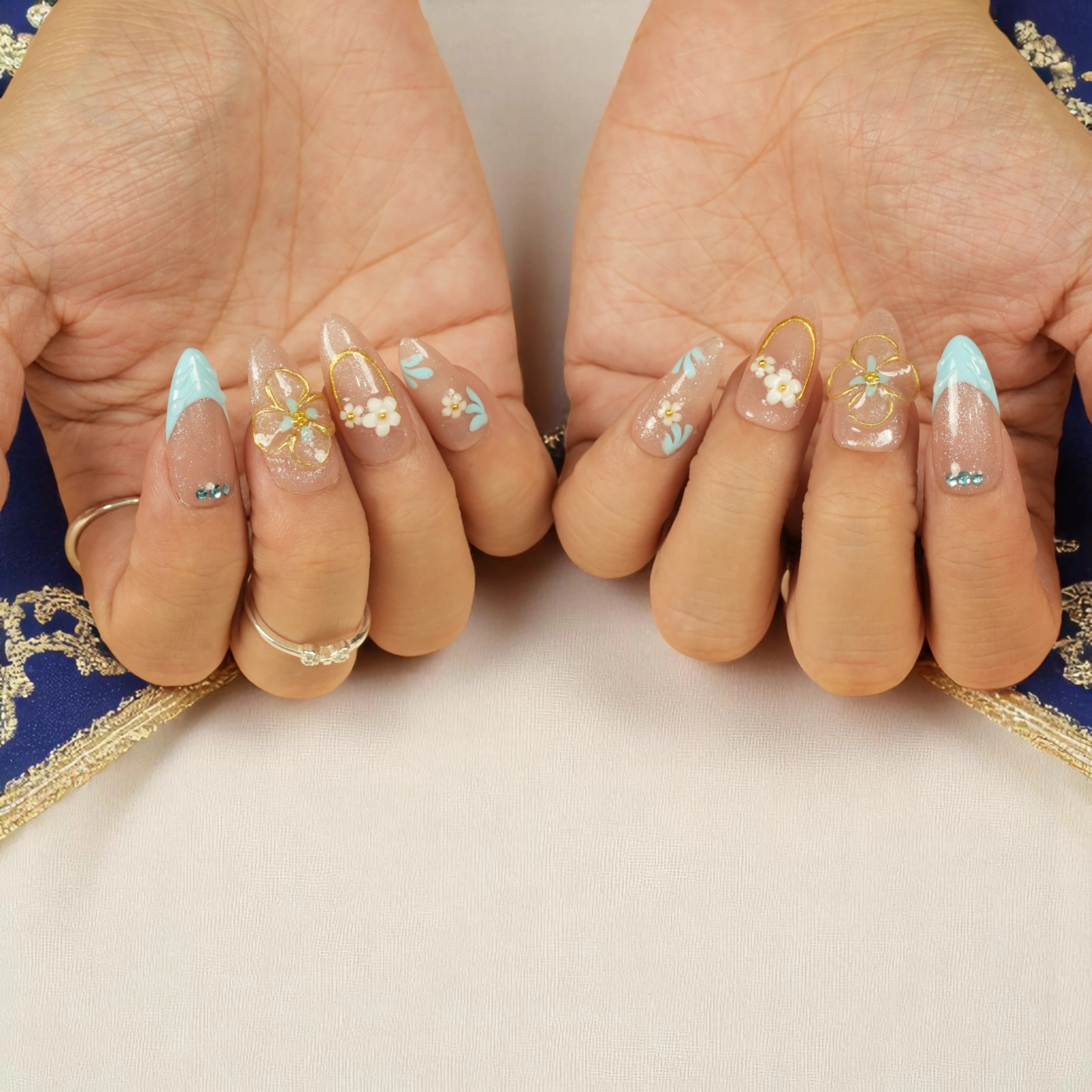 Bluebell Bloom floral press on nails shown on hands with detailed pearl and flower design