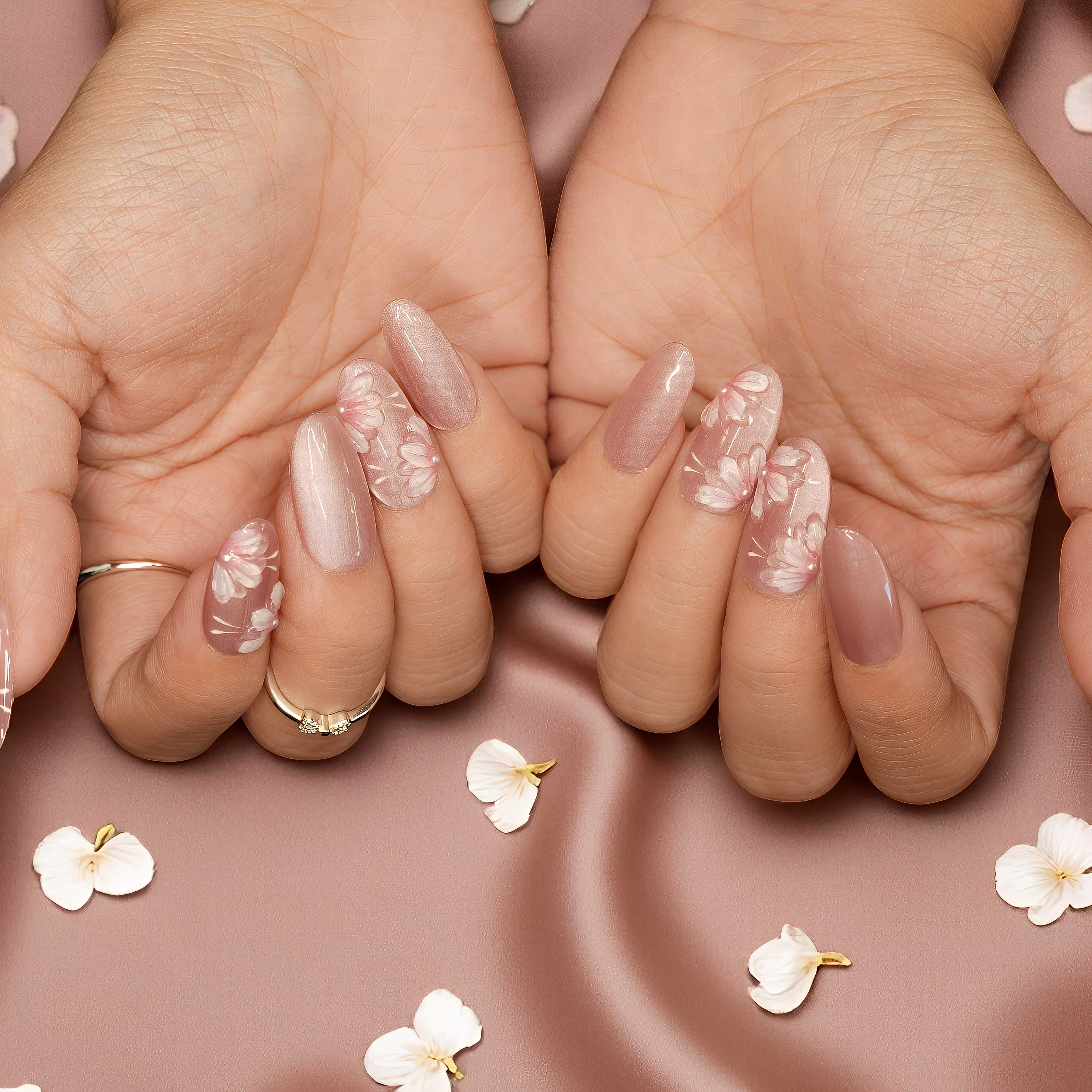 Side angle of Petal Whisper nails highlighting the shimmer finish and flower accents.