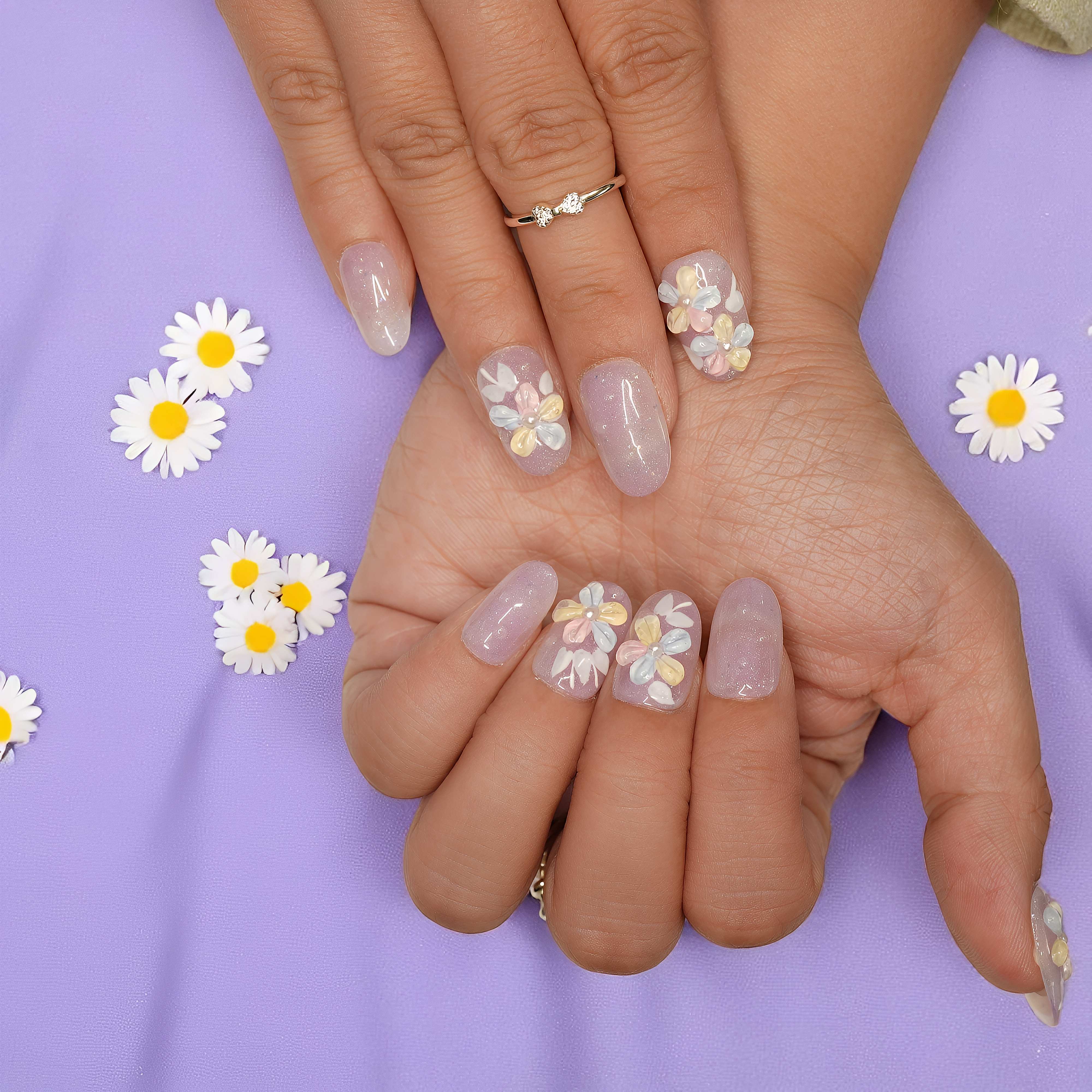 oth hands facing forward, showing full Bloomlight Daydream press on nail set with soft sparkle and 3D flower designs