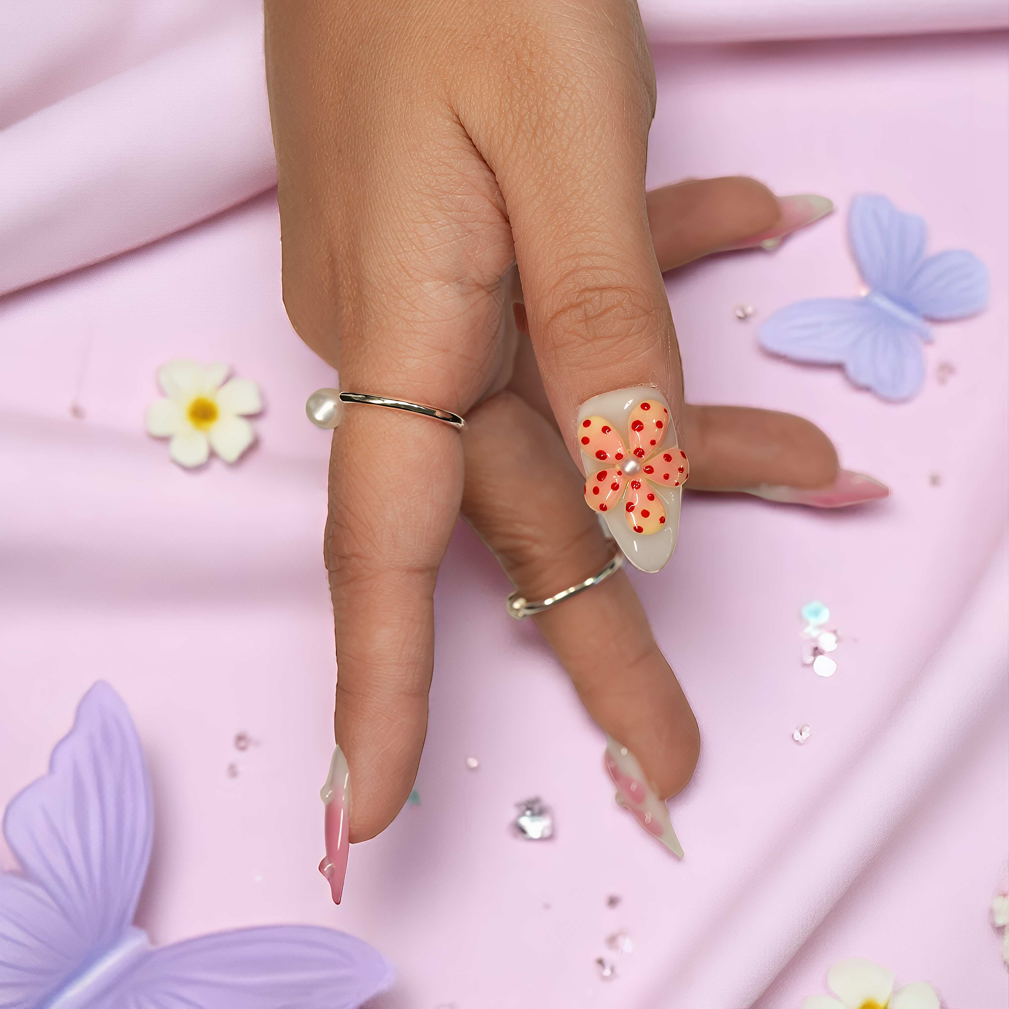 Side pose of thumb featuring a 3D polka dot flower nail from the Petal Pop press on collection, perfect for playful spring looks