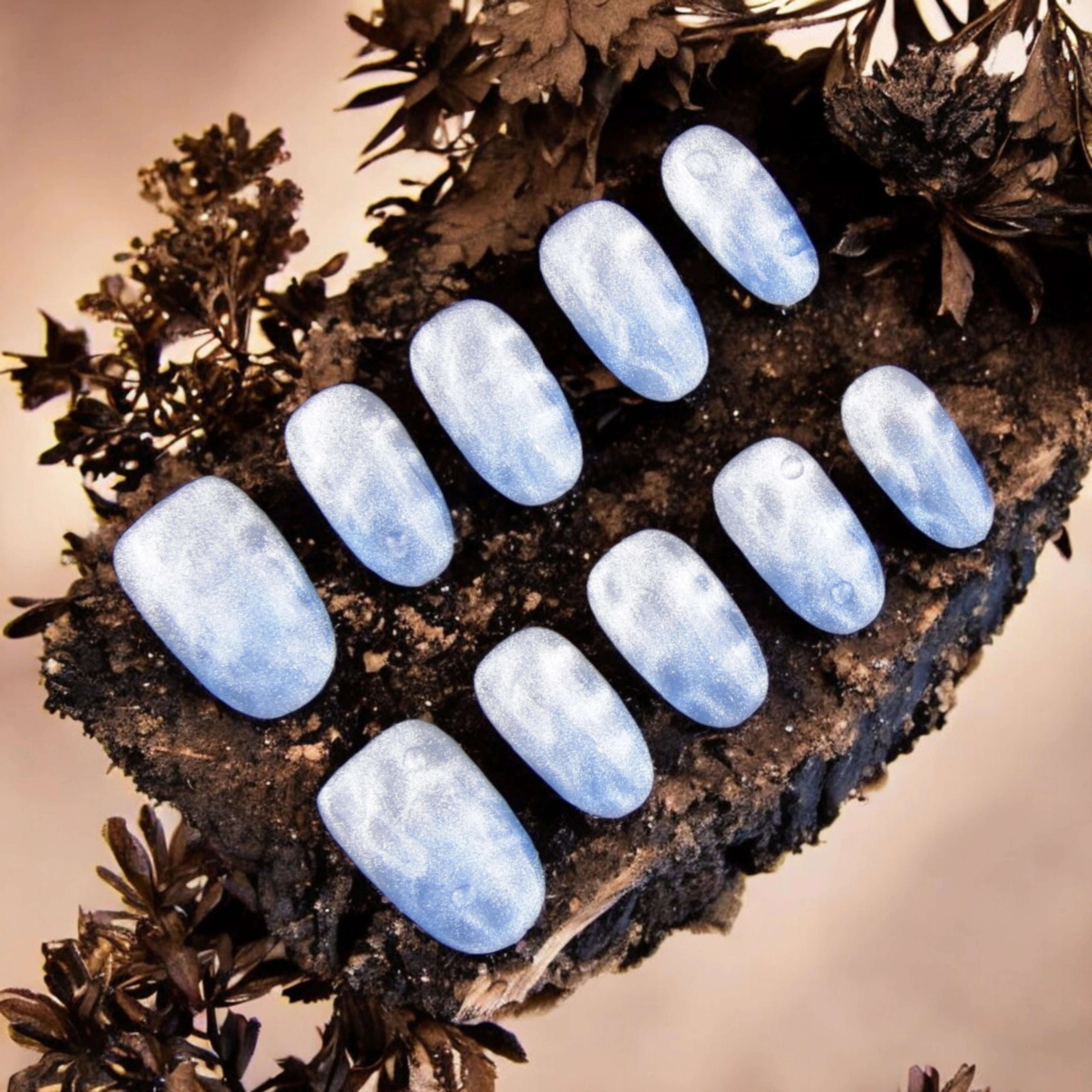 Shimmering blue ocean-inspired artificial nails with a water ripple effect, designed for a dreamy beach manicure