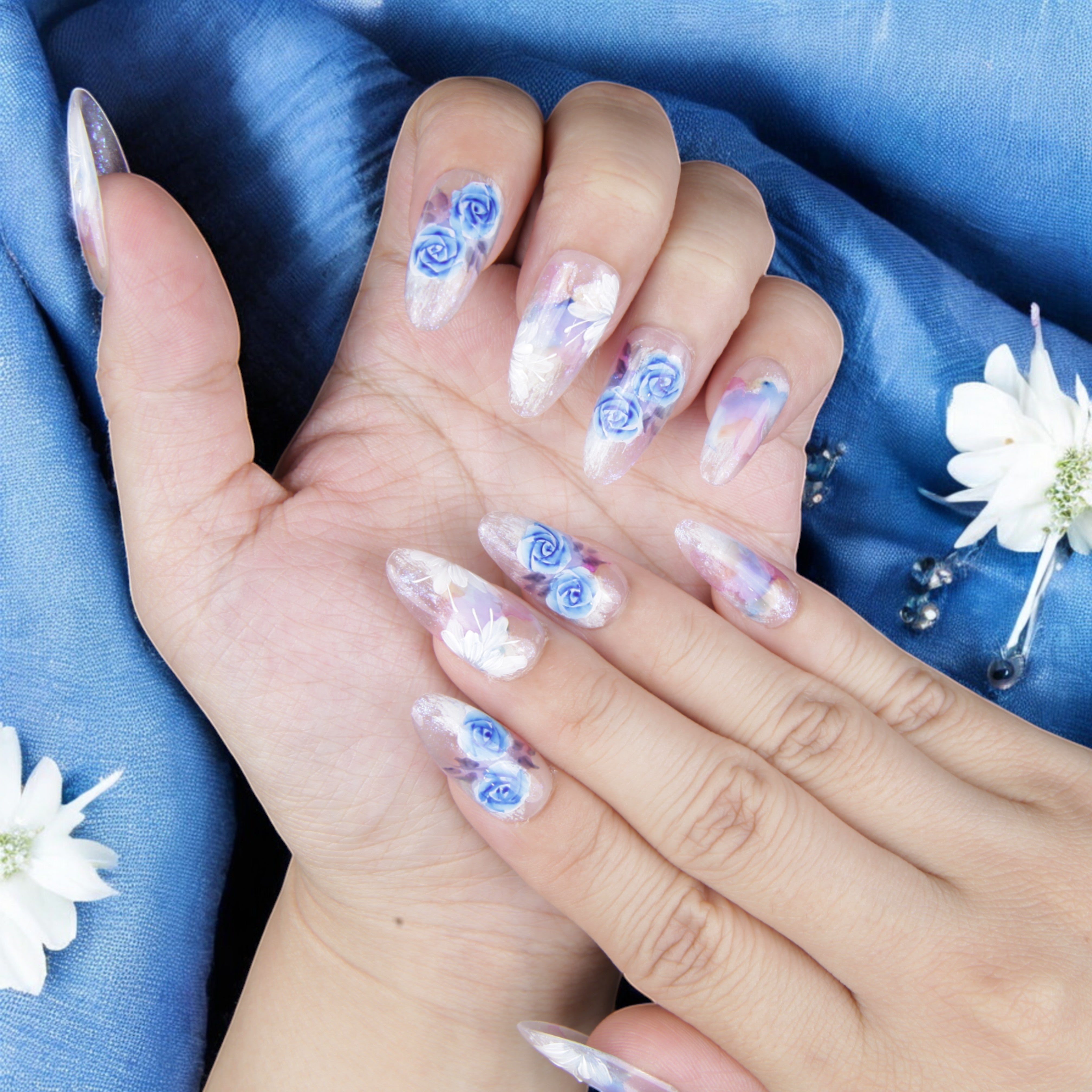 Luxury glue-on nails with blue rose details, soft watercolor accents, and delicate shimmer. High-quality false nails for an effortless salon look