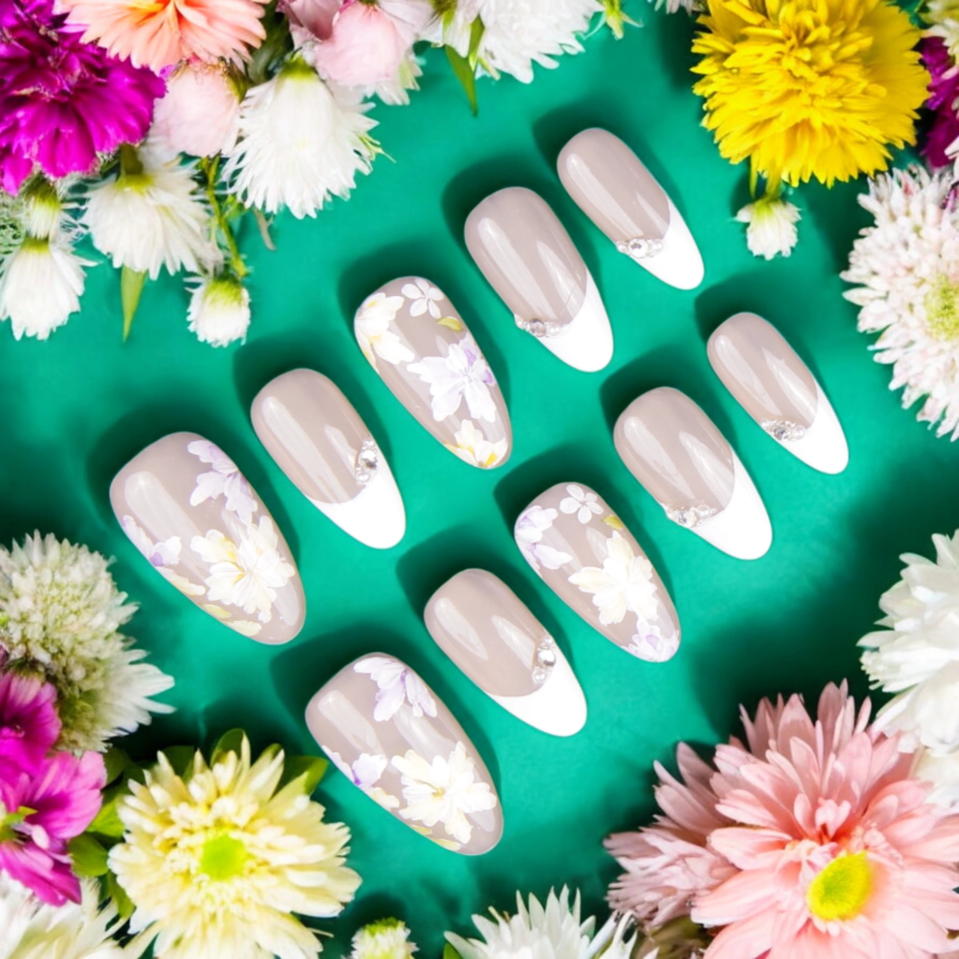 Elegant floral French tip press on nails with soft nude and white contrast, featuring intricate hand-painted daisy designs.