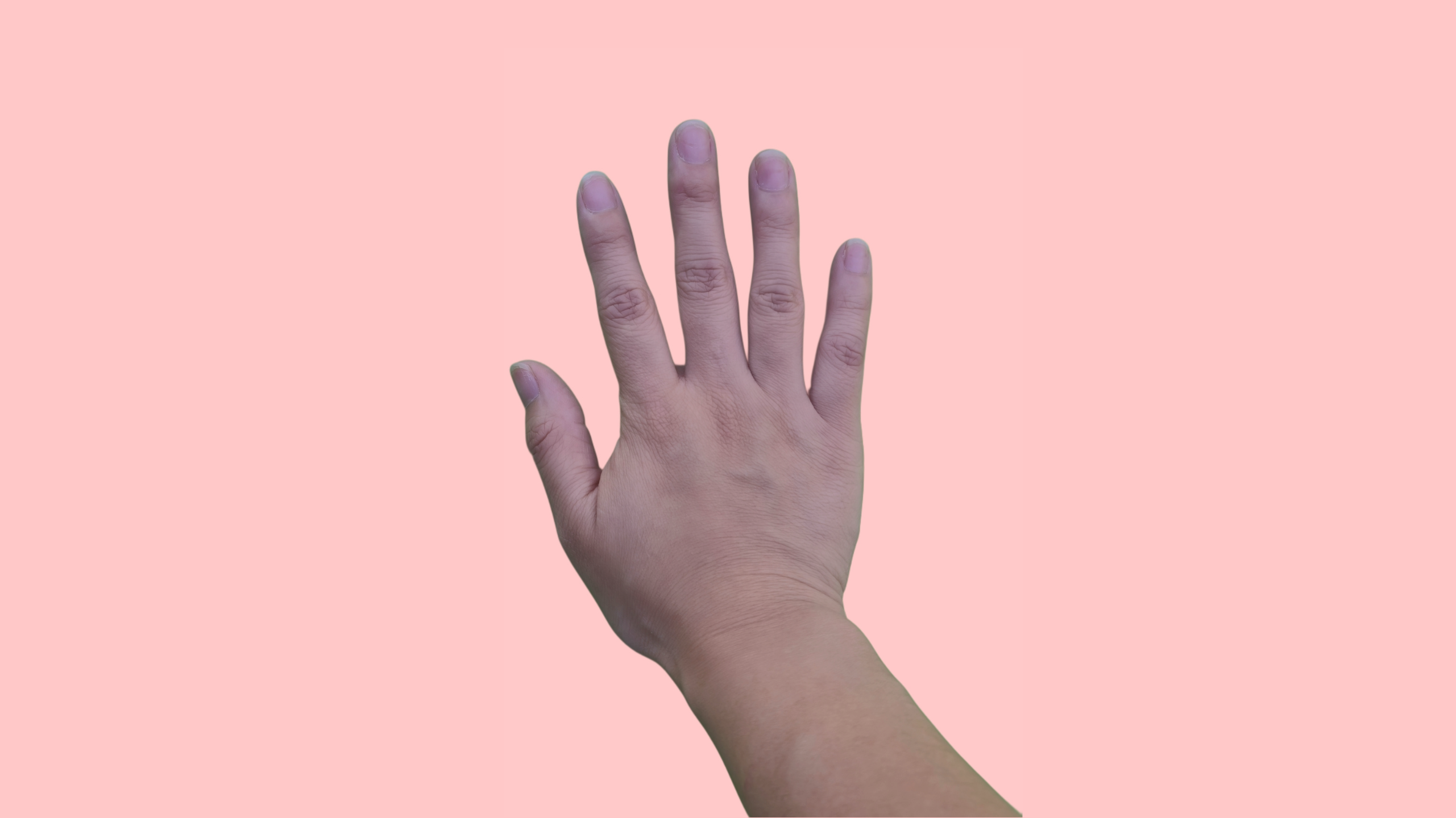 Natural hand before press on nails application, shown against a soft pastel pink background — ready for a nail transformation