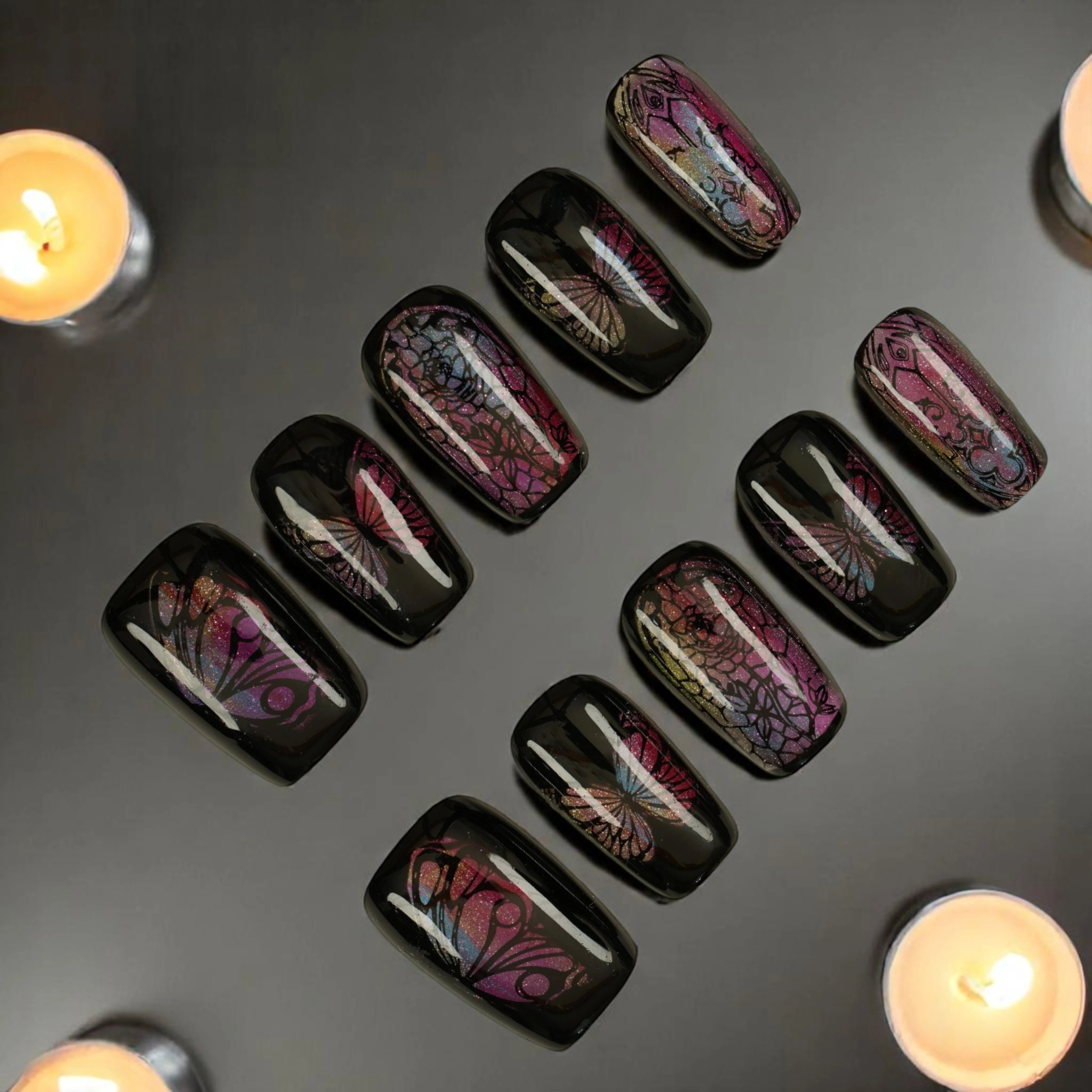 Gothic press on nails with butterfly wings and stained glass patterns, featuring black base and iridescent pink shimmer. Glue on nails Australia