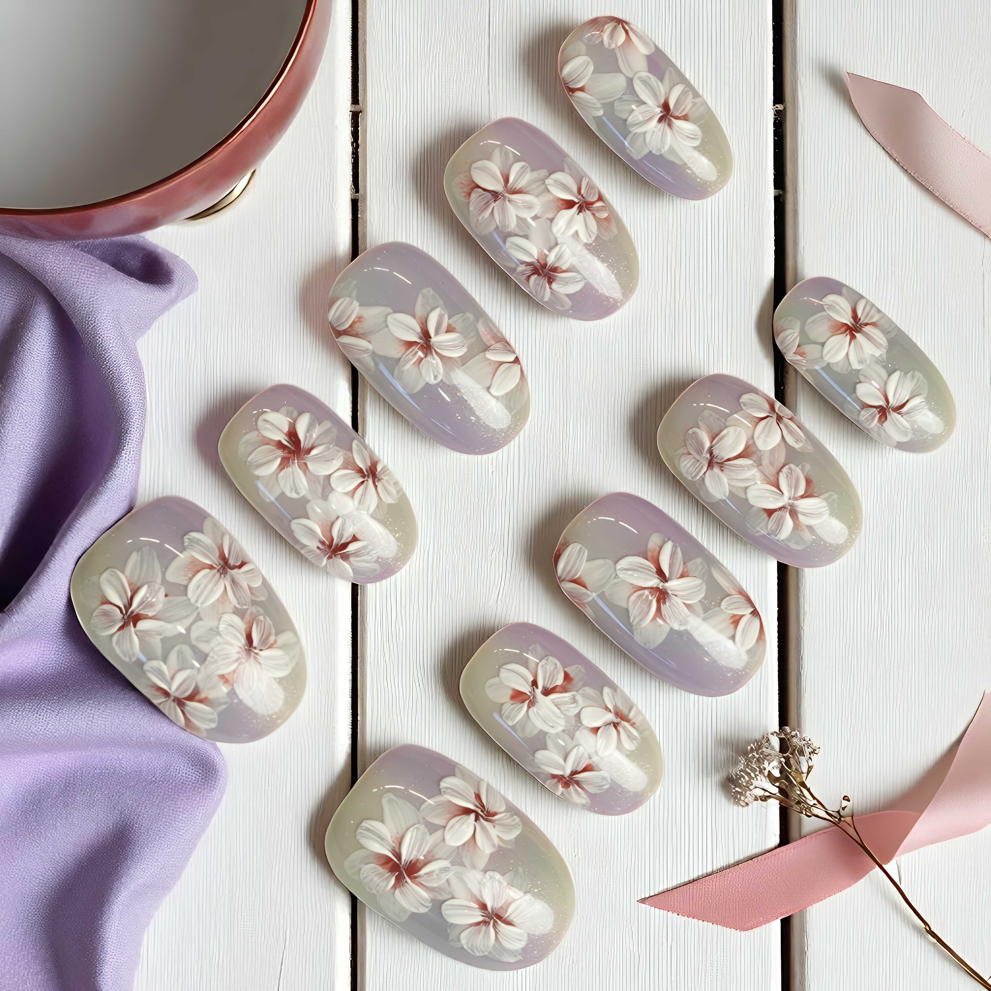Nail art stickers with floral design on a white wooden surface