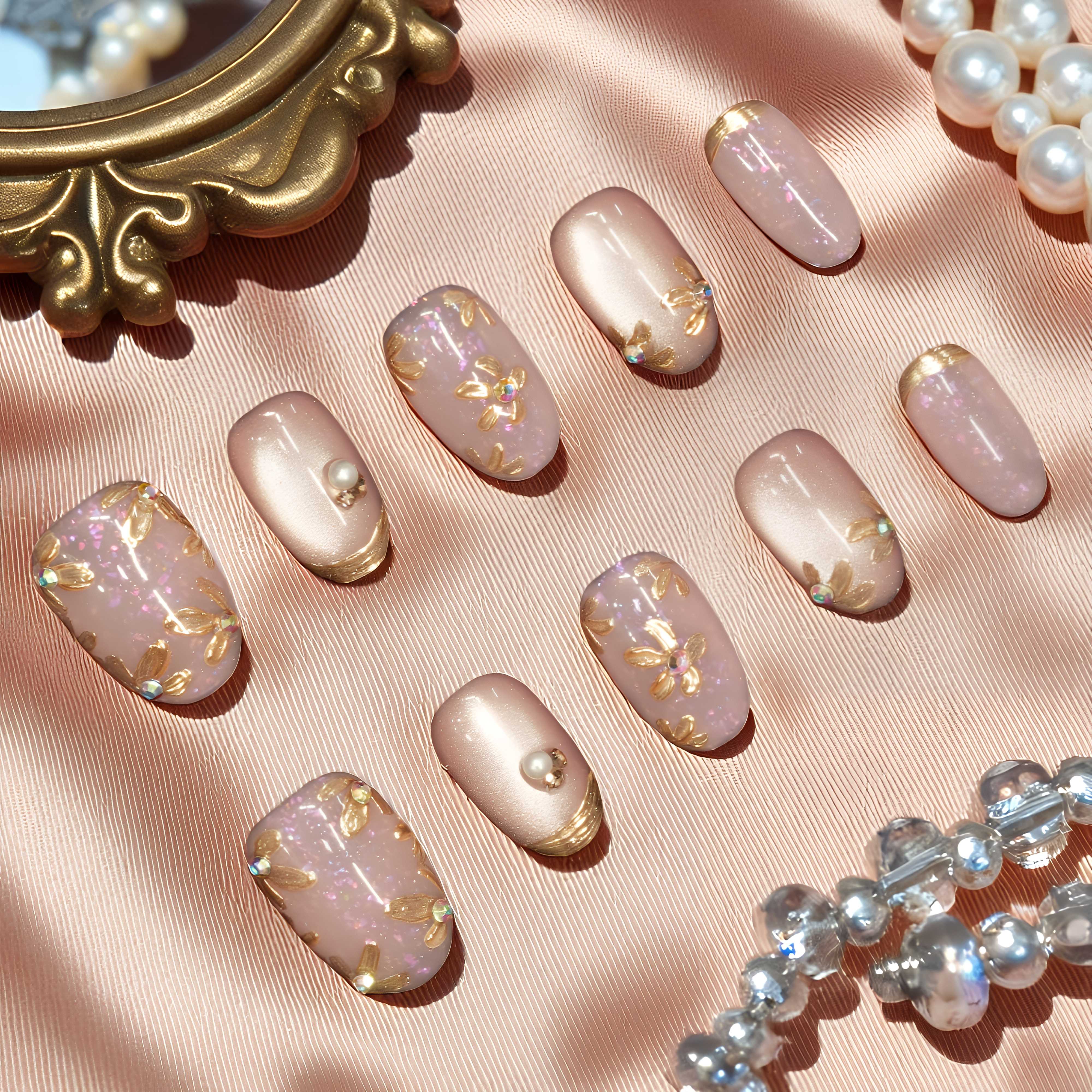 Gold floral cat’s eye nails with shimmer and pearl embellishments