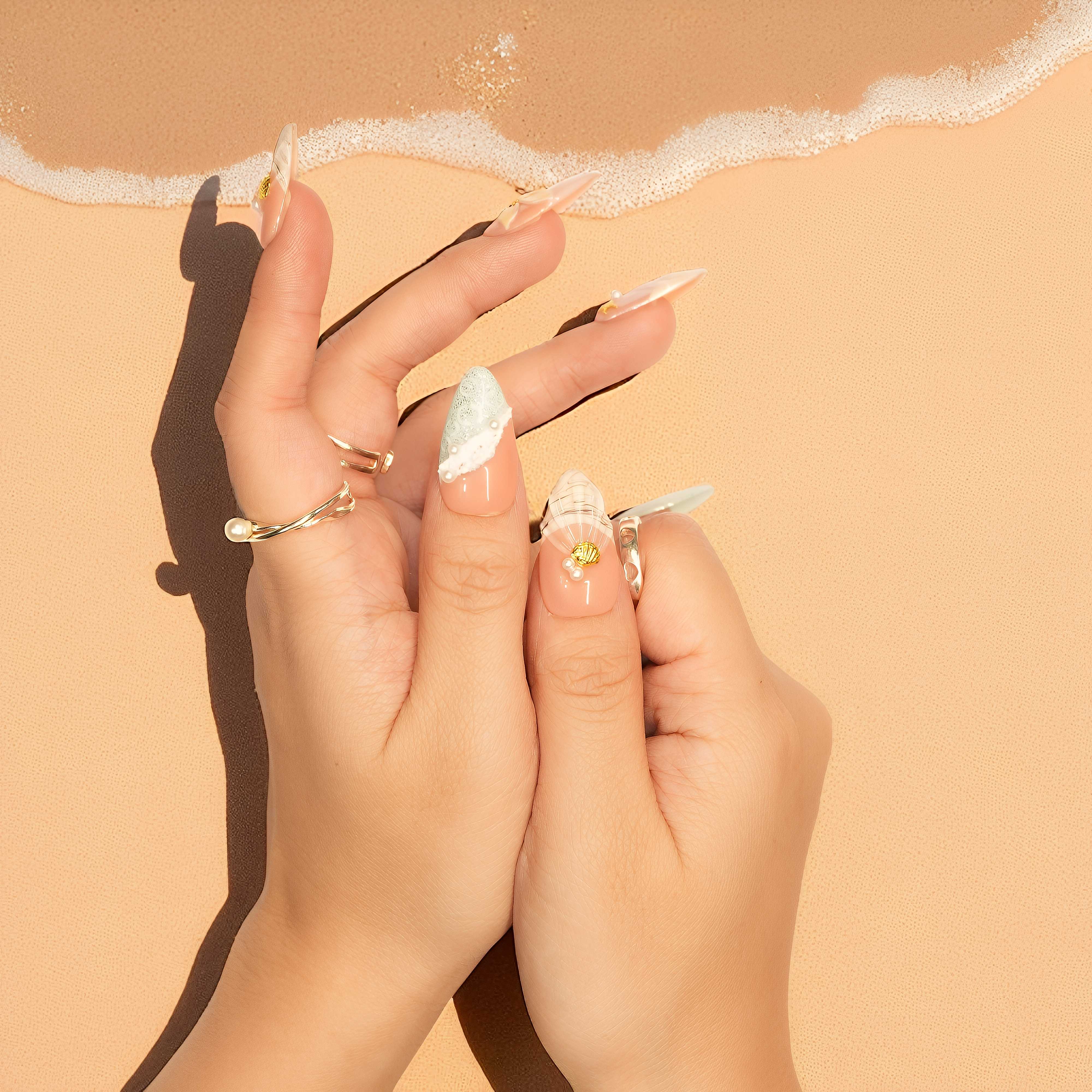 Handcrafted nail press on nails in soft peach and mint green tones