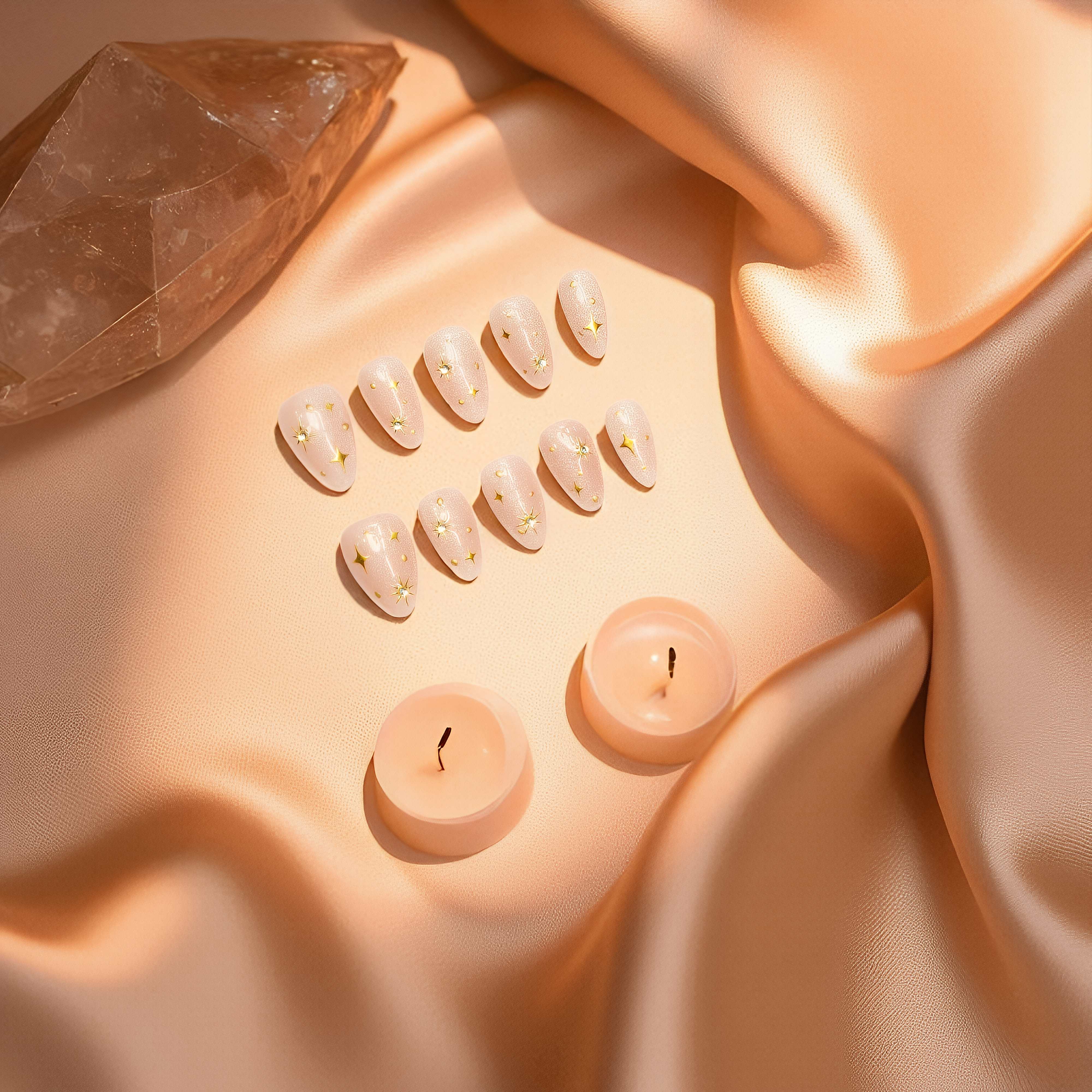 Set of small candles and crystal on a soft fabric surface