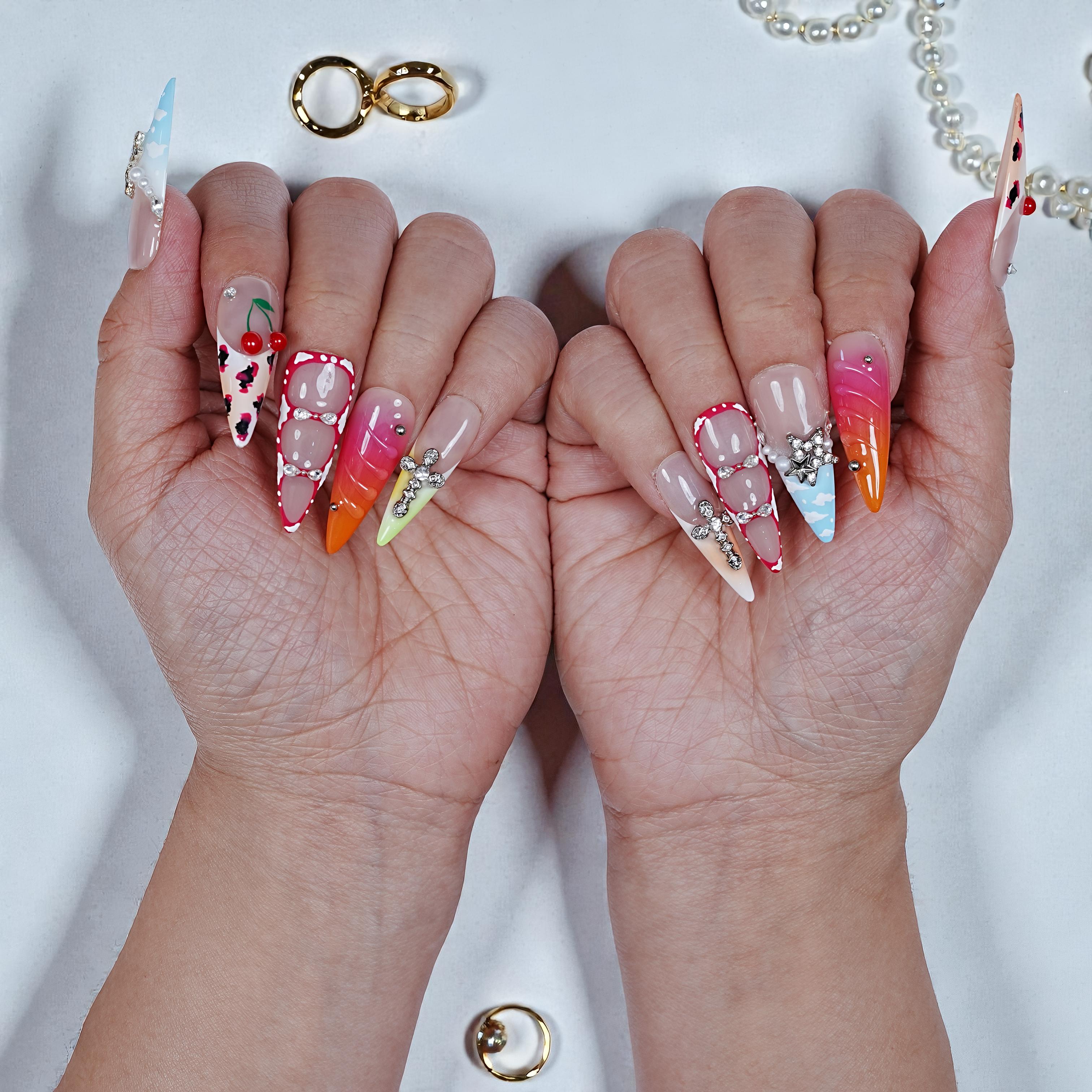 Close-up of hands with colorful nail art on a white background