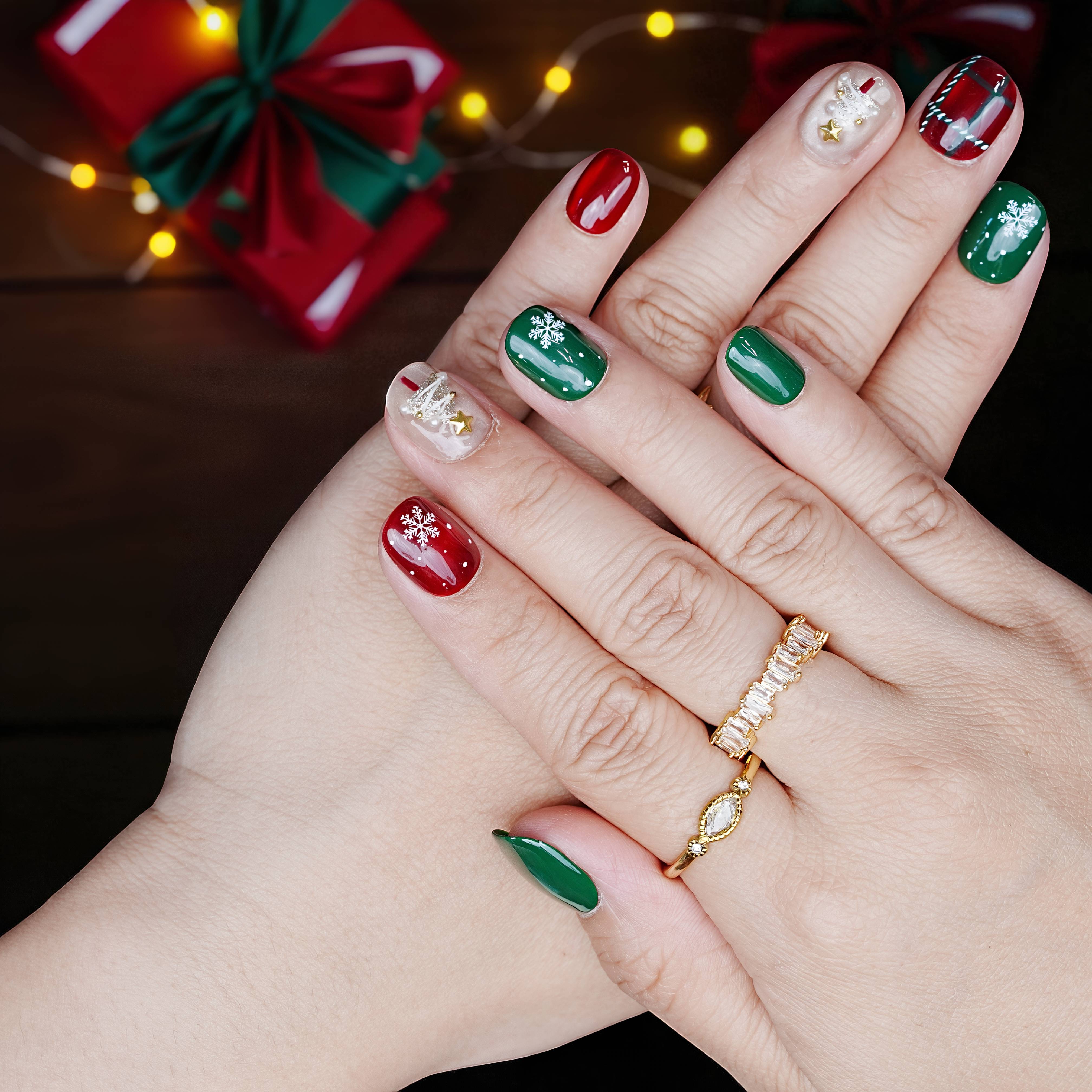 Christmas themed press on nails with gold snowflakes and red-green combos