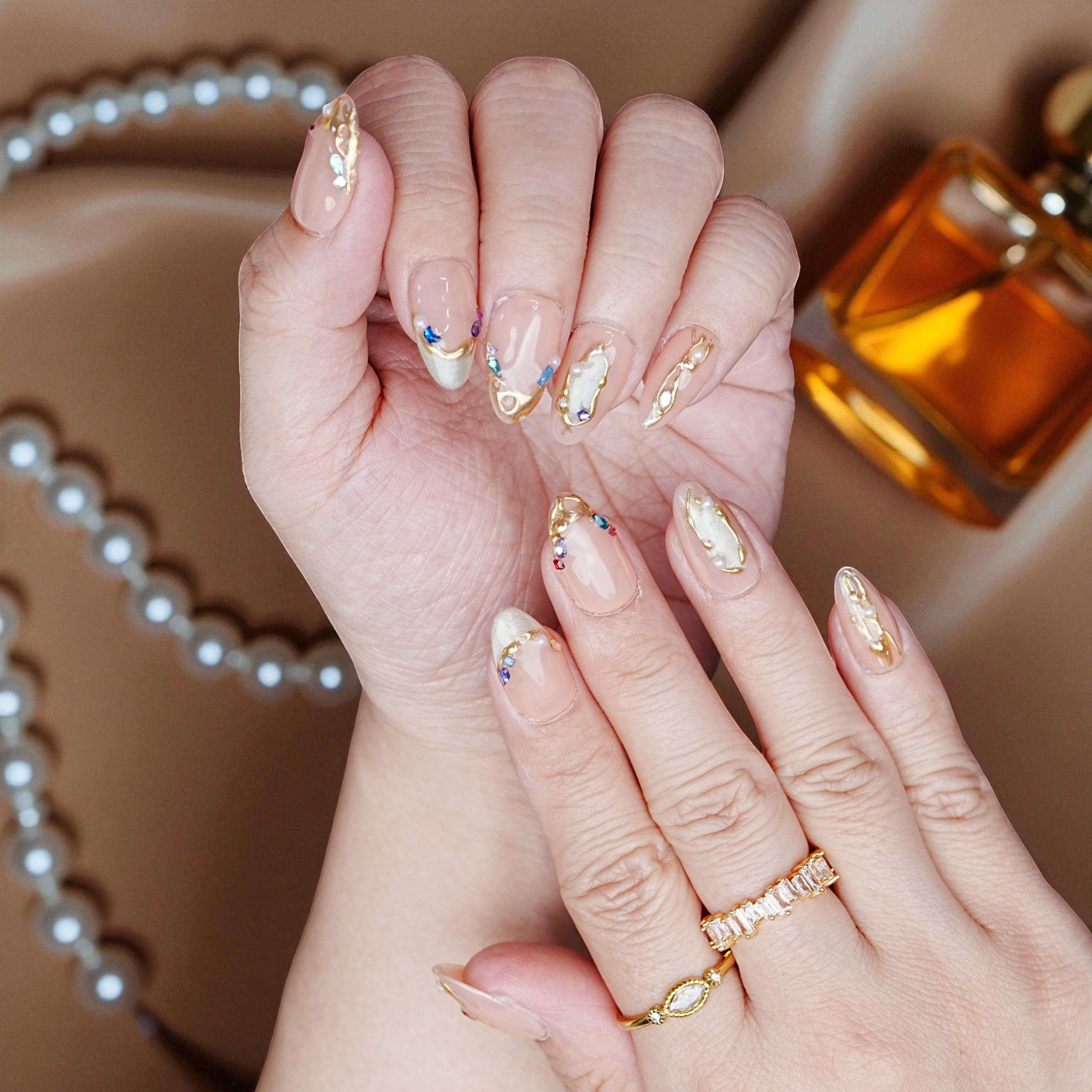 Shimmery blush chrome nails with 3D flowers and petal details