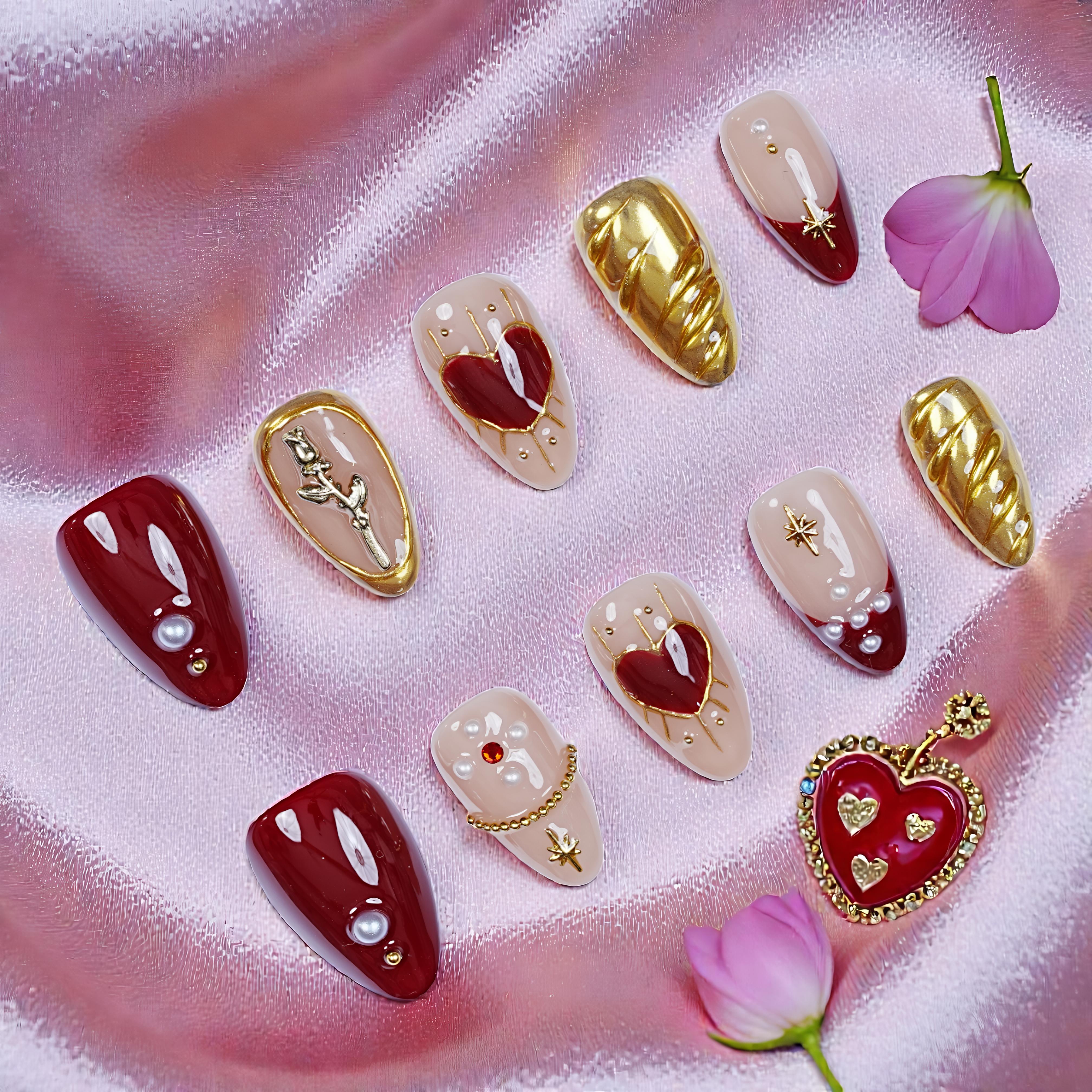 Handmade press on nails with gold, red, and heart designs on pink satin, Australia