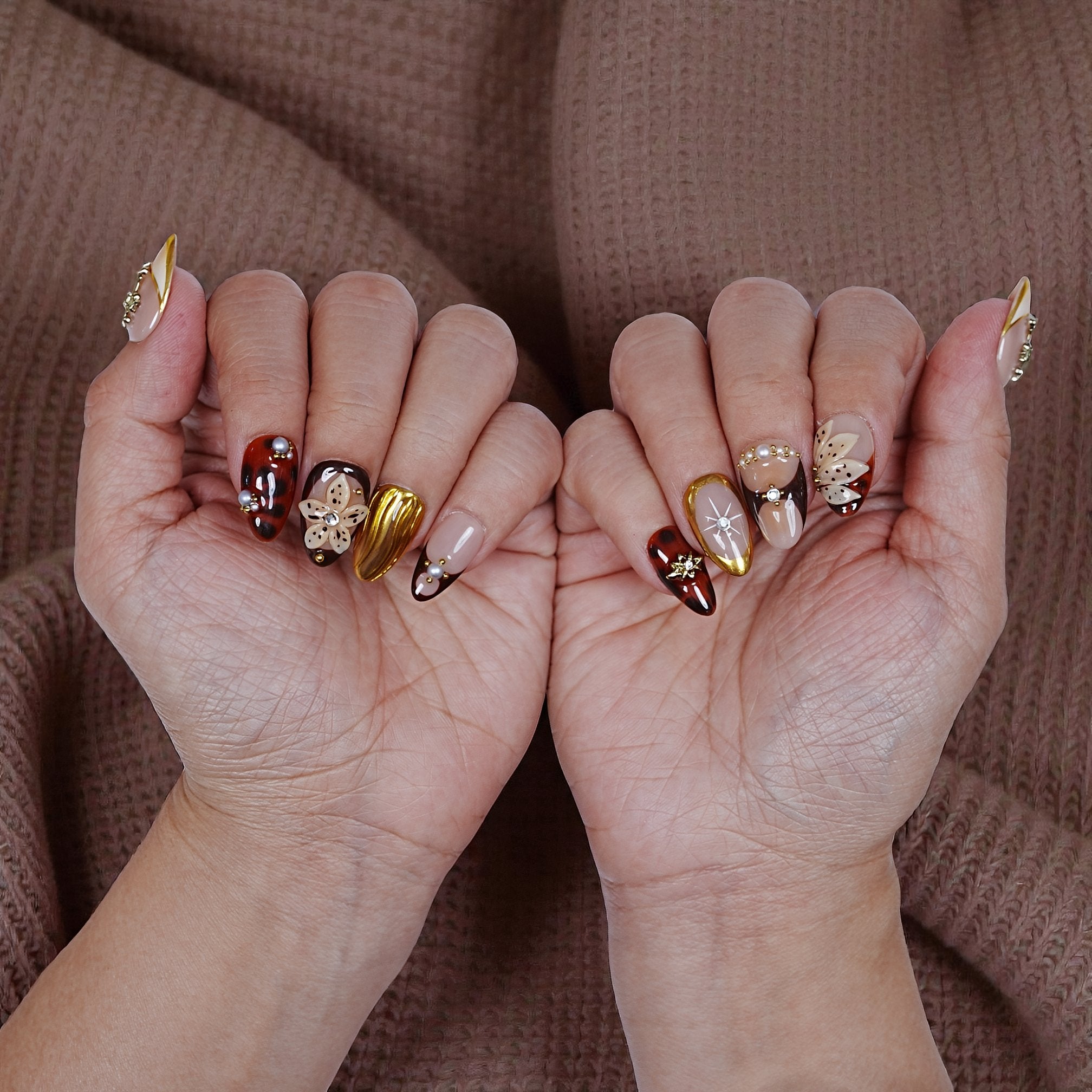 Luxury press on nails set displayed with detailed gold elements