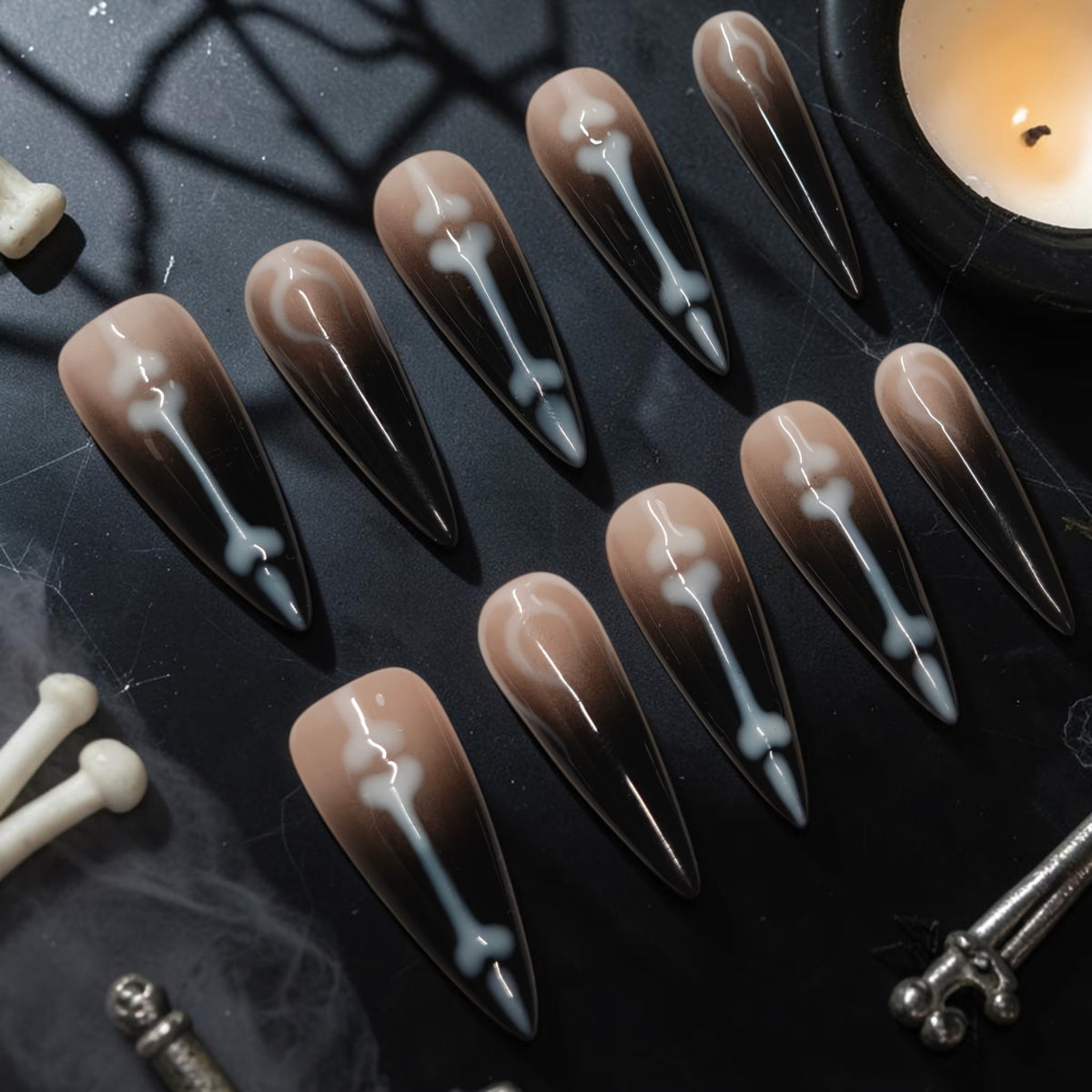 Graveyard Shift skeleton press on nails, black ombre stiletto set with white bones and crescent moons for Halloween