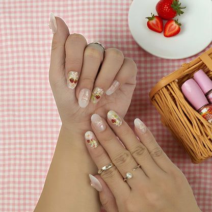 Glossy nude base nails with painted strawberries, white flowers, and glimmer foil flakes