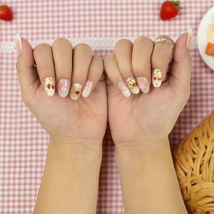 Side view of strawberry nails showing 3D shimmer detail and glossy jelly nude tone