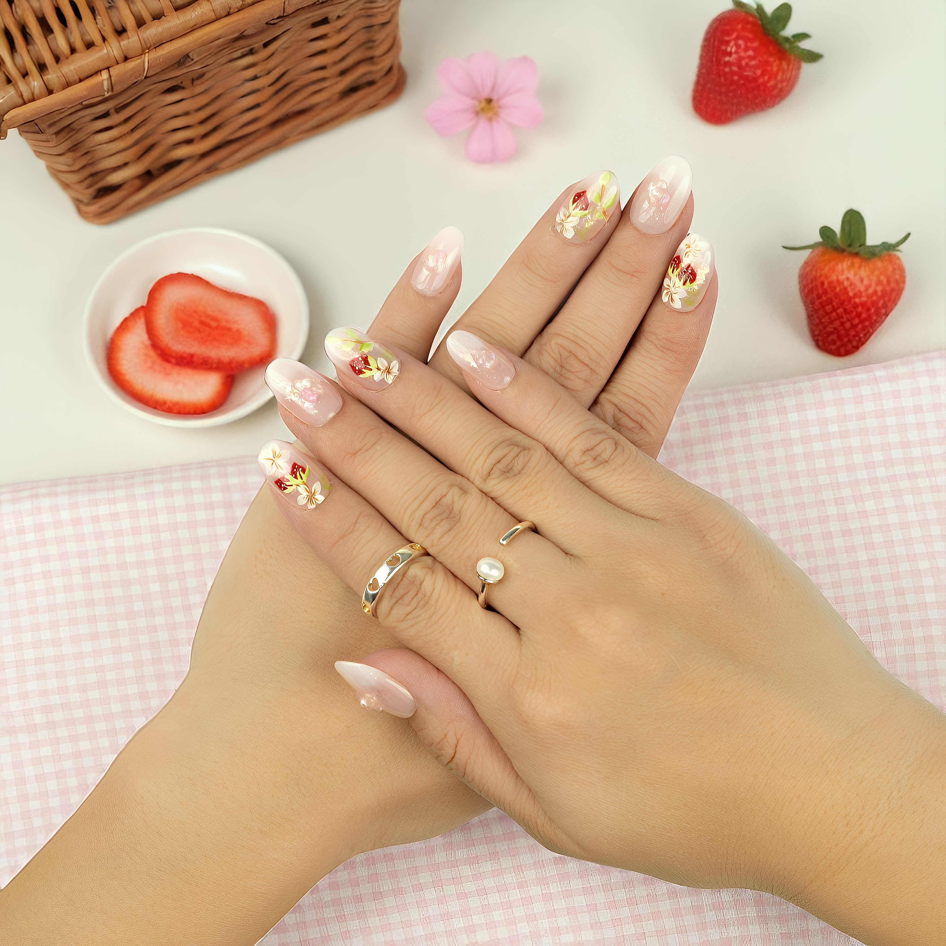 Reusable strawberry press on nails with painted leaves, floral design, and glitter accents