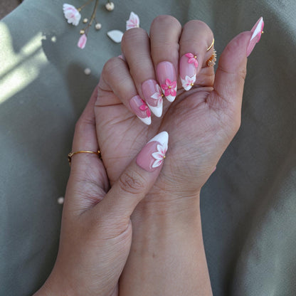 Soft blush pink almond nails with white French tips and 3D floral art