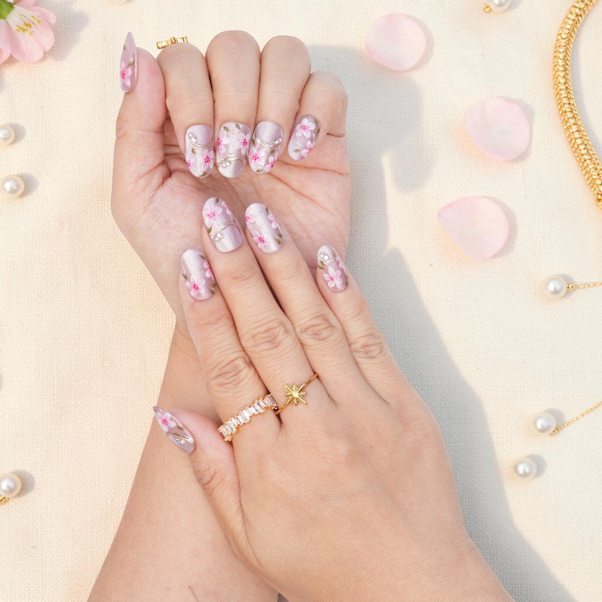 DSC00013 close up of pink sakura blossoms and gold lines on pearly press on nails