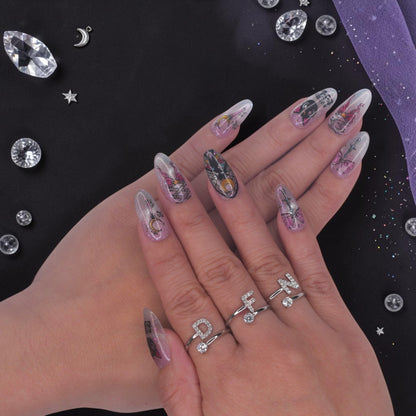 DSC00013 hand wearing anime press on nails with a magical girl silhouette, black cat and moon wand