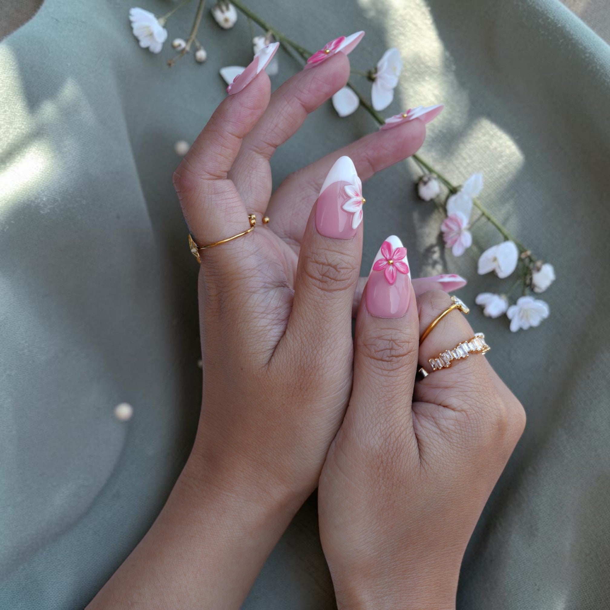 Close up of a pink 3D flower on a sheer nude pink press on nail