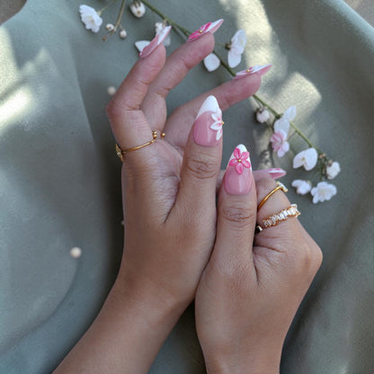 Close up of a pink 3D flower on a sheer nude pink press on nail
