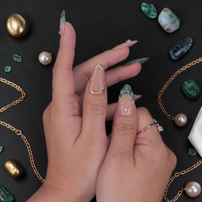 DSC00031 hand wearing emerald press on nails with green marble, gold framing and pearl chrome