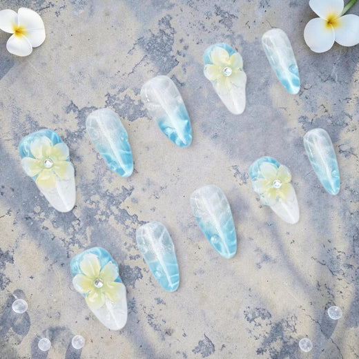 DSC00032 frangipani press on nails full set with 3D flowers on an ocean blue cat eye base laid flat