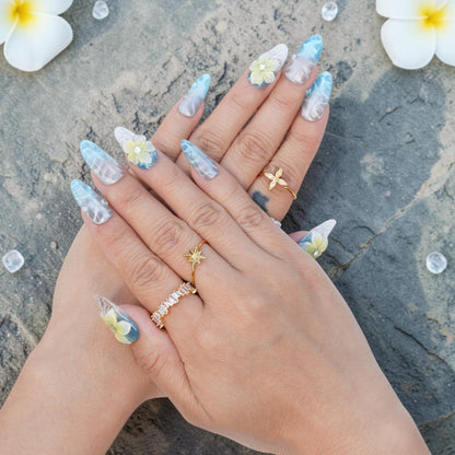 DSC00033 hands wearing blue frangipani press on nails with 3D flowers and gold rings