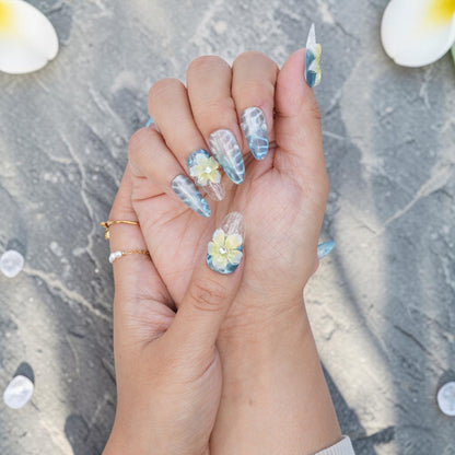 DSC00037 blue and white frangipani press on nails held up in the light