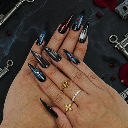 DSC00040 hand wearing long stiletto vampire press on nails with red gems and gothic art