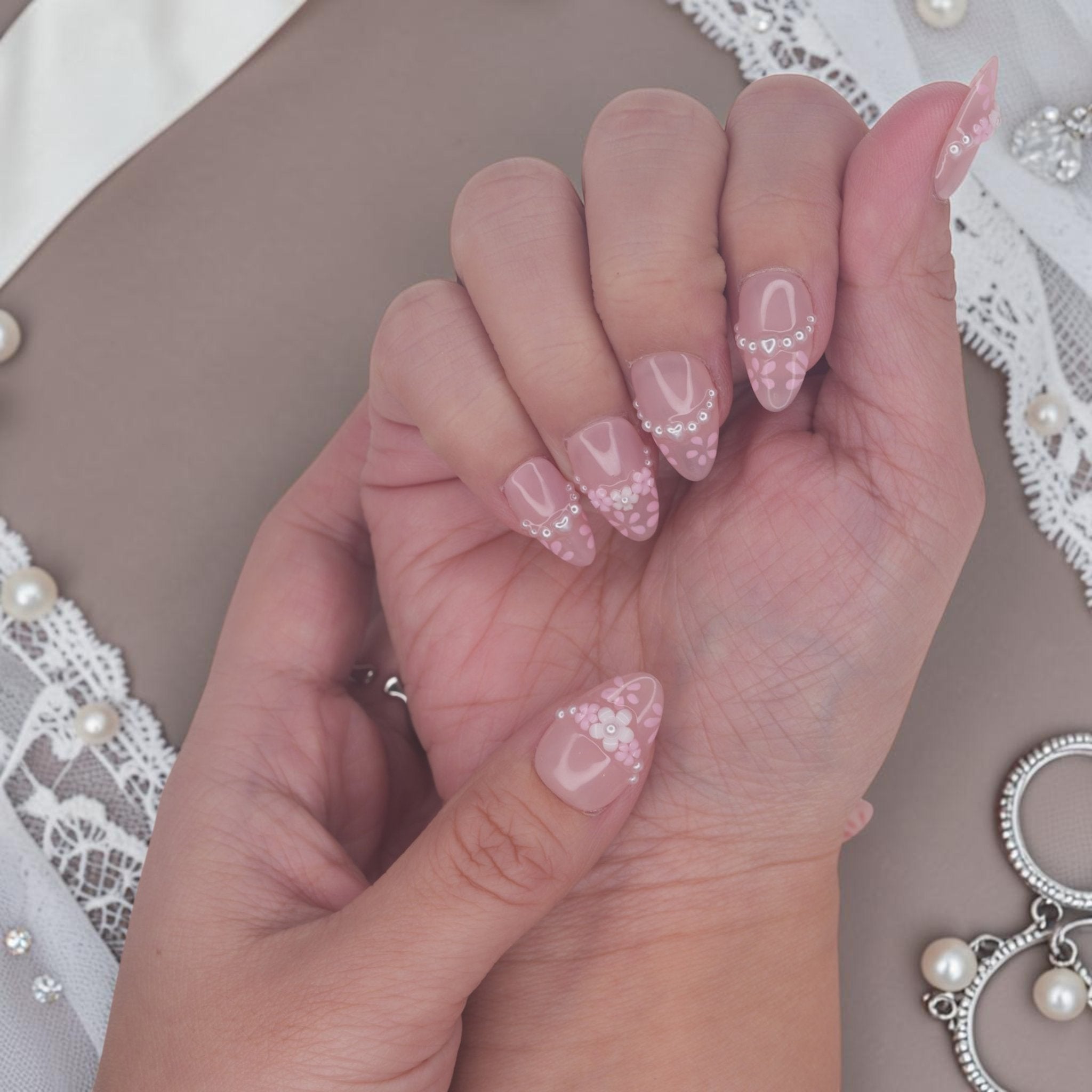 DSC00044 hands wearing coquette press on nails with pink french tips, 3D flowers and pearls