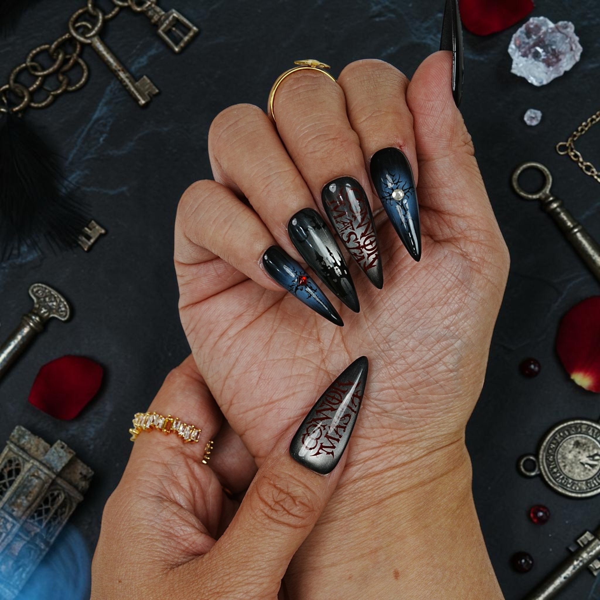 DSC00044 close up of vampire press on nails with a blood red gem set in a cracked black nail
