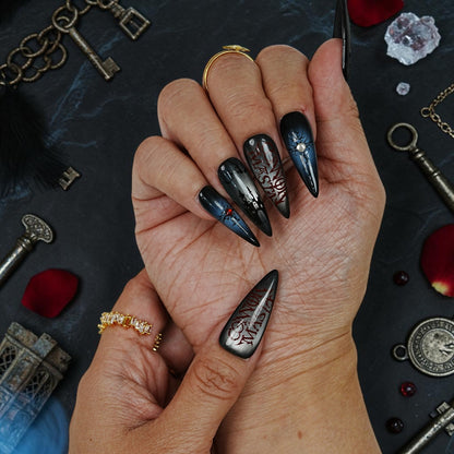 DSC00044 close up of vampire press on nails with a blood red gem set in a cracked black nail