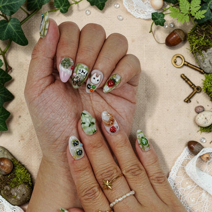 DSC00053 close up of matcha press on nails with a 3D croissant, strawberry and green leaf