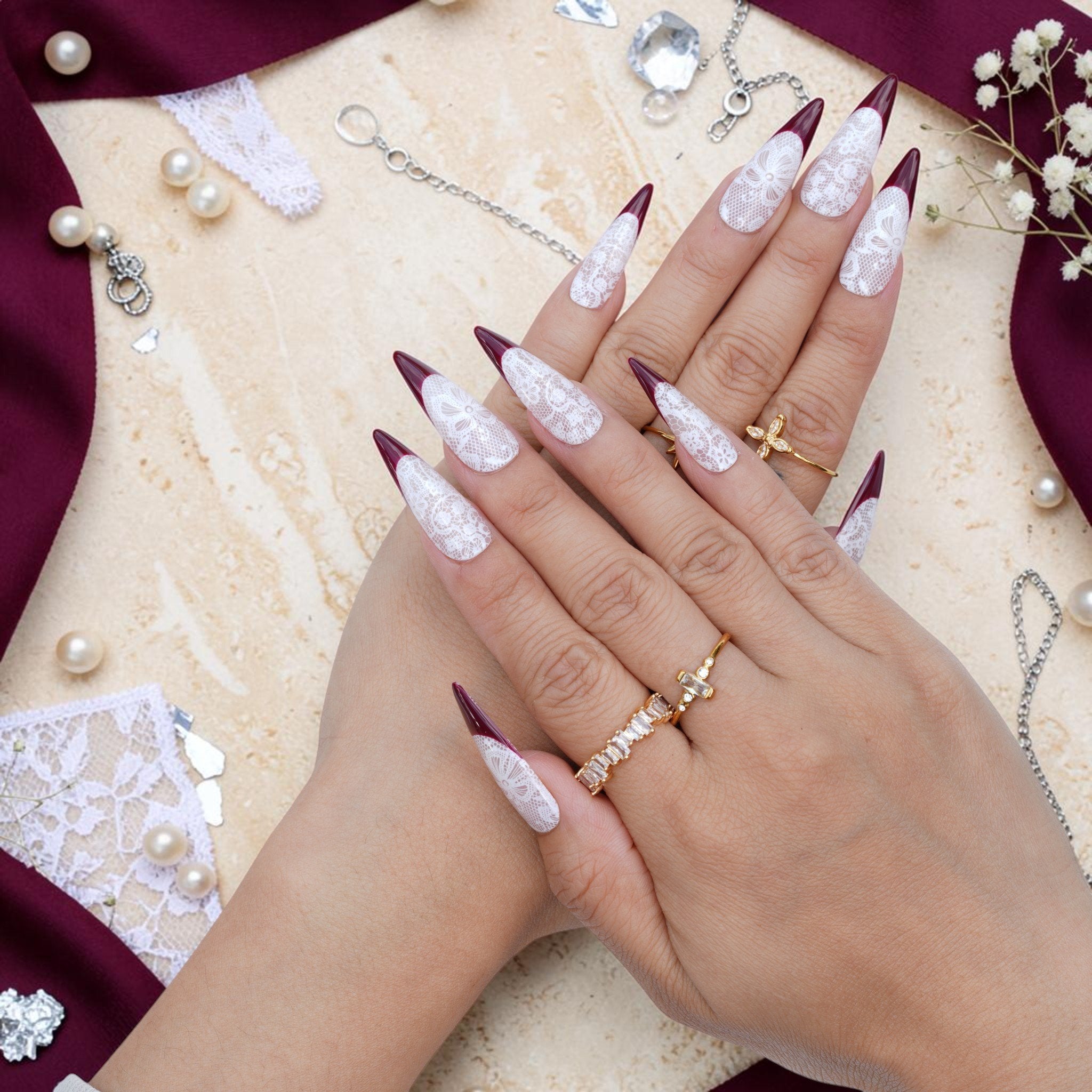 DSC00062 hands wearing burgundy and white lace stiletto press on nails with rings