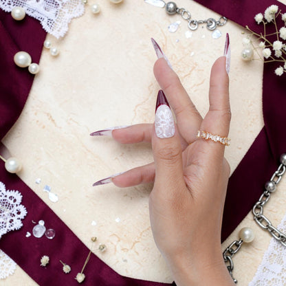 DSC00063 close up of white lace floral design on a burgundy tipped press on nail